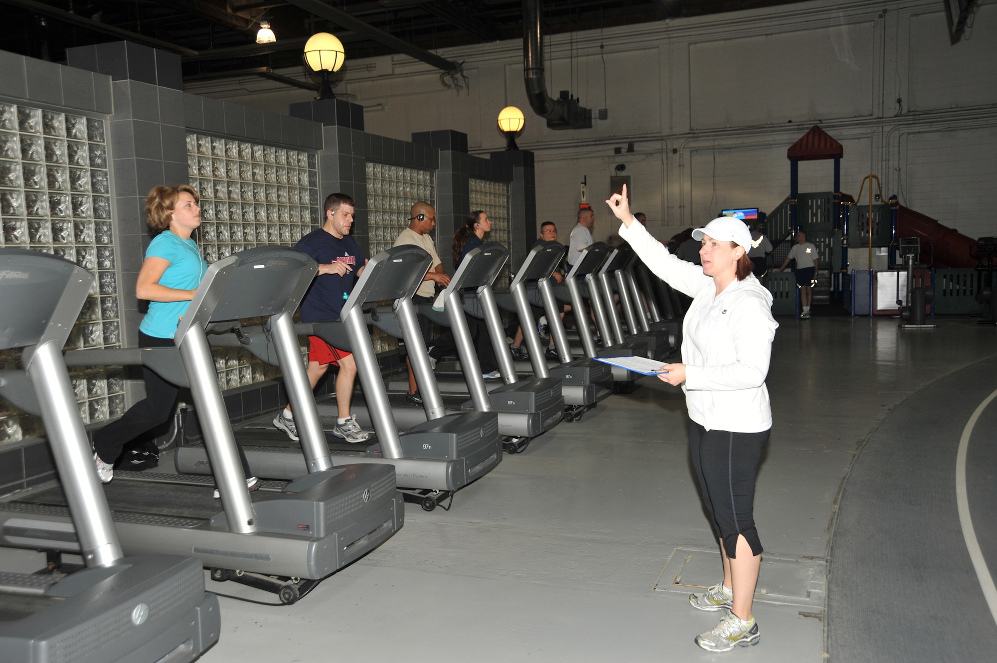 Marcy Jameson gestures to participants in the Get Fit Run class at Offutt Air Force Base, Neb. Ms. Jameson is an exercise physiologist and the health and wellness center flight chief at Offutt AFB. (U.S. Air Force photo/D.P. Heard) 