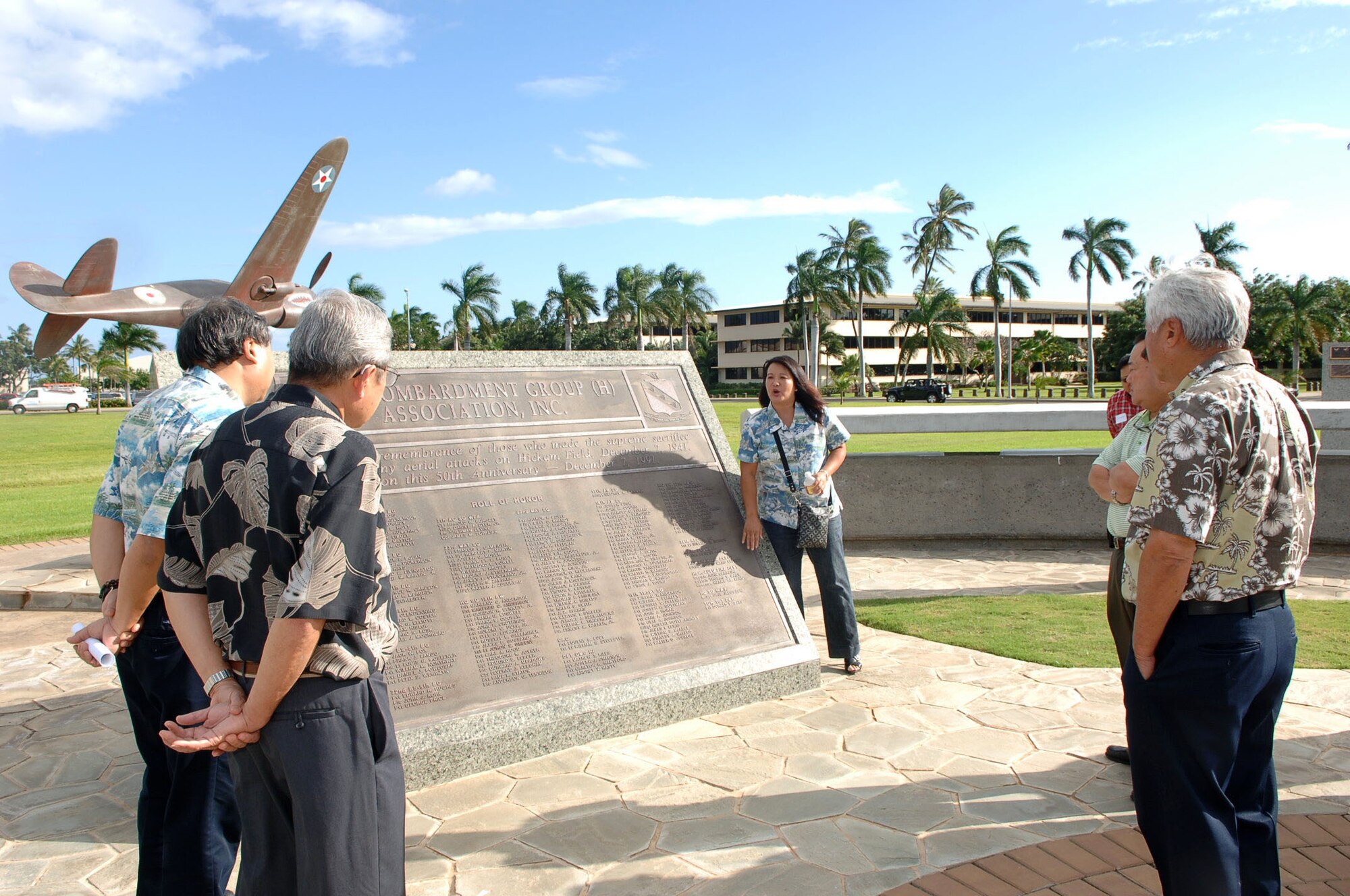 Jessie Higa, a volunteer historian for the base, gives a tour of the Atterbury Circle flagpole area during an orientation tour and social for Friends of Hickam members Mar. 10 at Joint Base Pearl Harbor-Hickam, Hawaii. The Friends of Hickam are local community representatives who serve as facilitators between the 15th Wing and the Hawaiian community and seek to support, promote and foster strong community relations with 15th Wing leaders. (Photo by David D. Underwood, Jr.)