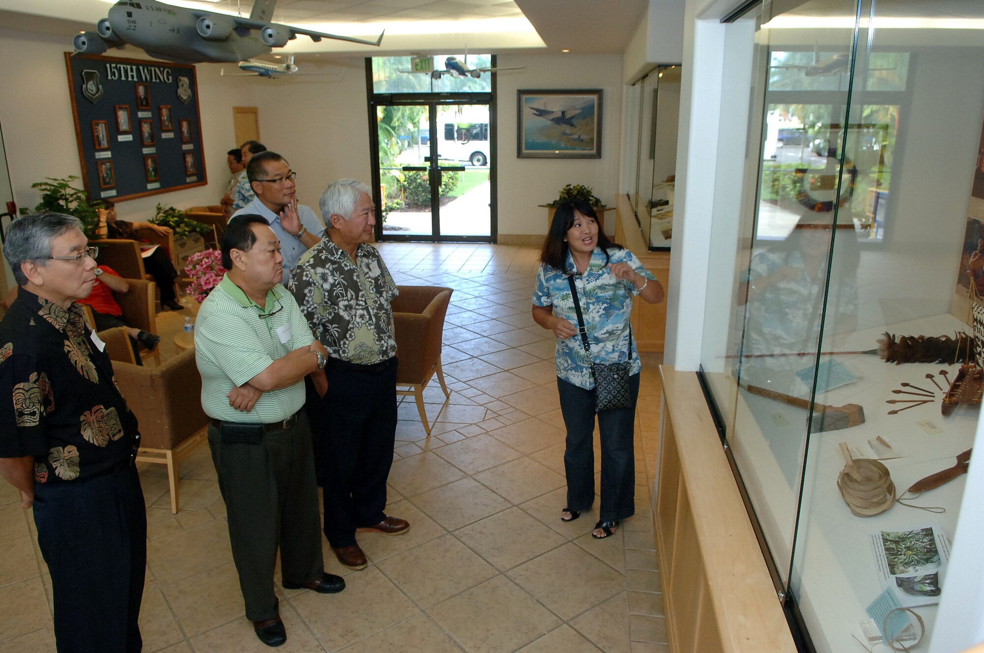 Jessie Higa, a volunteer historian for the base, gives a tour of the 15th Wing headquarters building to members of the Friends of Hickam community group Mar. 10 at Joint Base Pearl Harbor-Hickam, Hawaii. The Friends of Hickam are local community representatives who serve as facilitators between the 15th Wing and the Hawaiian community and seek to support, promote and foster strong community relations with 15th Wing leaders. (Photo by David D. Underwood, Jr.)