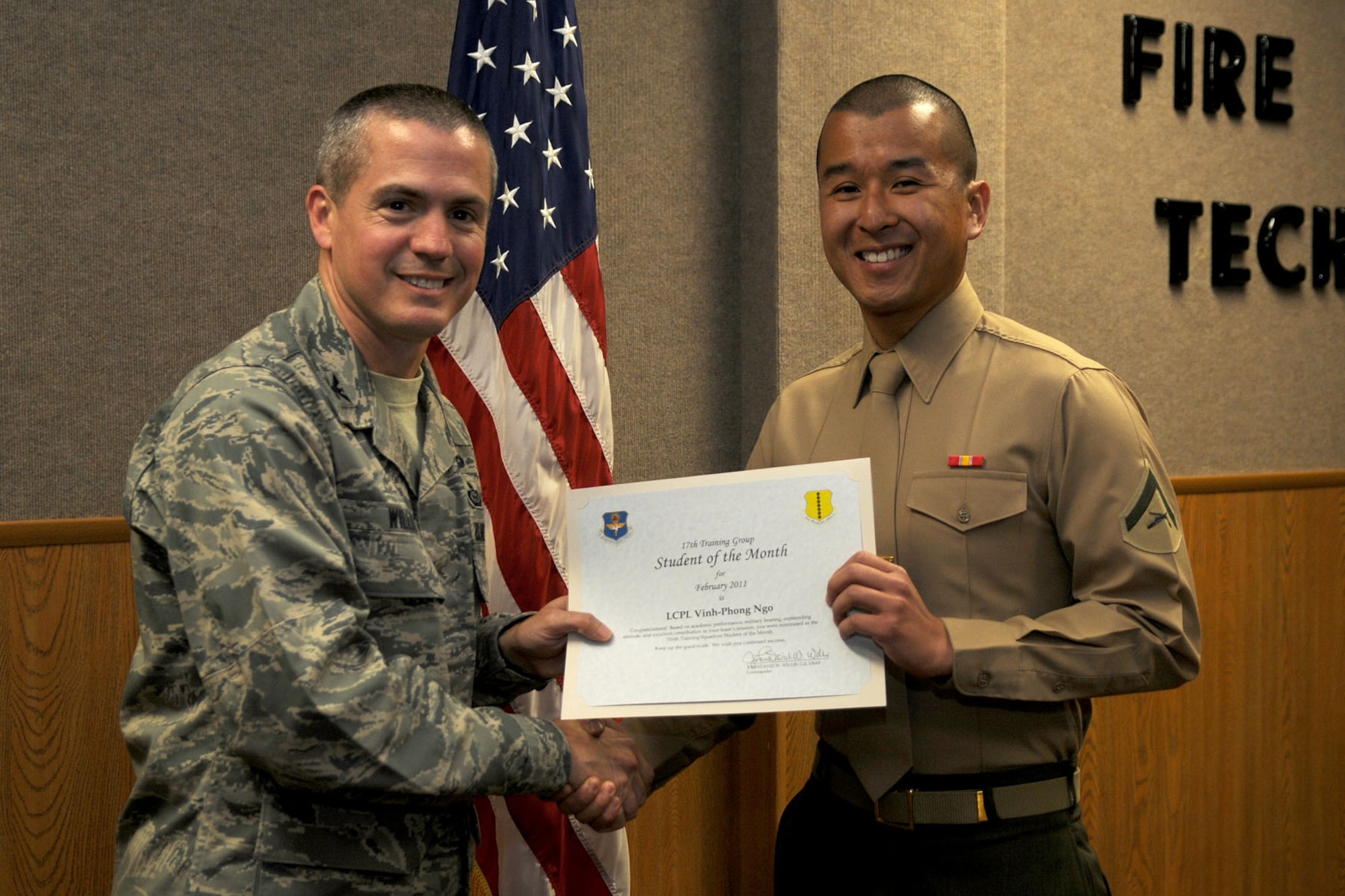 GOODFELLOW AIR FORCE BASE, Texas -- Marine Lance Cpl. Vinh-Phong Ngo, 316th Training Squadron student, receives his February Student of the Month certificate from Col. J.D. Willis, 17th Training Group Commander.  (U.S. Air Force photo/Staff Sgt. Heather L Rodgers)