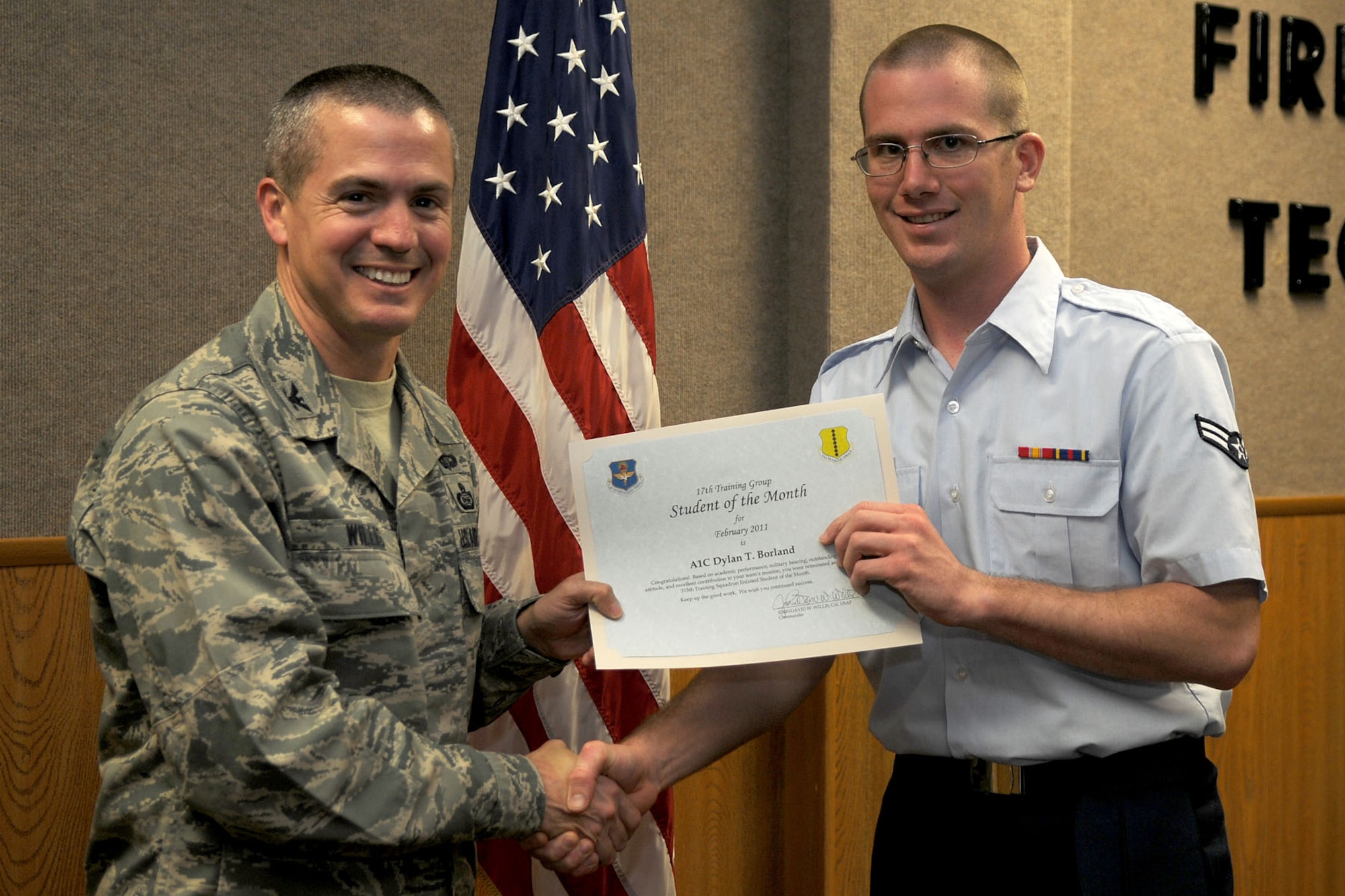 GOODFELLOW AIR FORCE BASE, Texas – Airman 1st Class Dylan Borland, 315th Training Squadron student, receives his February Student of the Month from Col. J.D. Willis, 17th Training Group Commander,  (U.S. Air Force photo/Staff Sgt. Heather L Rodgers)
