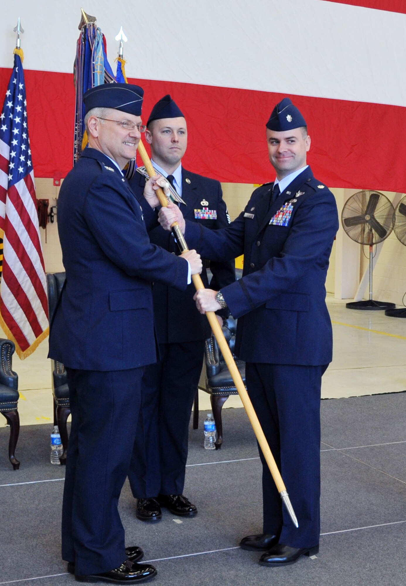 Lt. Col. Jon Julian, (right) accepted the guidon and, as such, assumed command of the 50th Airlift Squadron March 11, 2011, at Little Rock Air Force Base, Ark. Handing off the guidon was Col. David Kasberg, 19th Operations Group commander, the presiding officer.  The 50th AS and its C-130 Hercules aircraft provide tactical airlift to support Air Mobility Command missions and Central Command missions in Southwest Asia, in addition to humanitarian relief operations. (U.S. Air Force photo by Airman 1st Class Rusty Frank)
