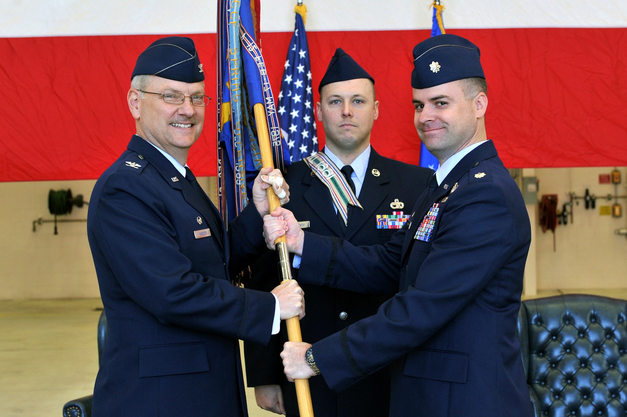 Lt. Col. Jon Julian, (right) accepted the guidon and, as such, assumed command of the 50th Airlift Squadron March 11, 2011, at Little Rock Air Force Base, Ark. Handing off the guidon was Col. David Kasberg, 19th Operations Group commander, the presiding officer.  The 50th AS and its C-130 Hercules aircraft provide tactical airlift to support Air Mobility Command missions and Central Command missions in Southwest Asia, in addition to humanitarian relief operations. (U.S. Air Force photo by Staff Sgt. Christopher Willis)