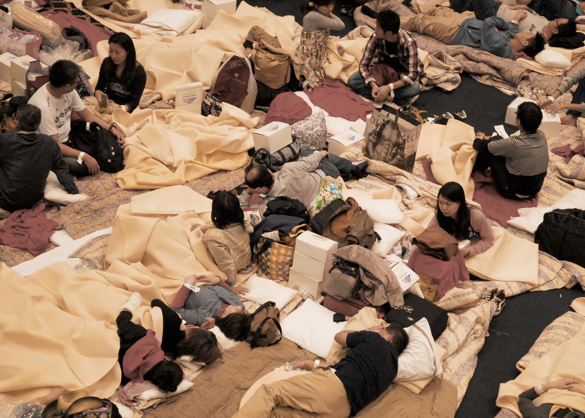 Passengers of a commercial airline flight take shelter March 11, 2011, at Yokota Air Base, Japan. Base officials there provided food and shelter to passengers of aircraft diverted from Narita International Airport in Tokyo, due to an 8.9-magnitude earthquake. (U.S. Air Force photo/Airman 1st Class Andrea Salazar)