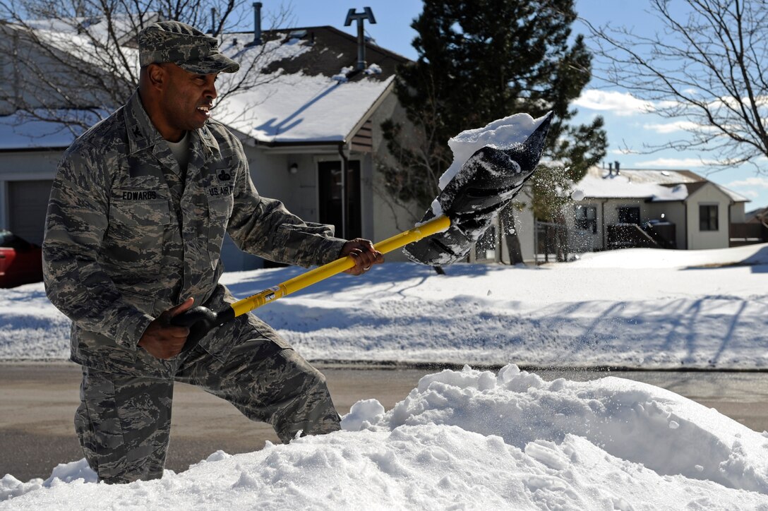Col. Trent Edwards, 28th Mission Support Group commander, shovels snow in front of an unoccupied house in base housing on Ellsworth Air Force Base, S.D., March 9, 2011.  Colonel Edwards encourages base housing occupants to focus on community safety by clearing snow on adjacent sidewalks within 24 hours after a snowfall. (U.S. Air Force photo/Staff Sgt. Marc I. Lane)