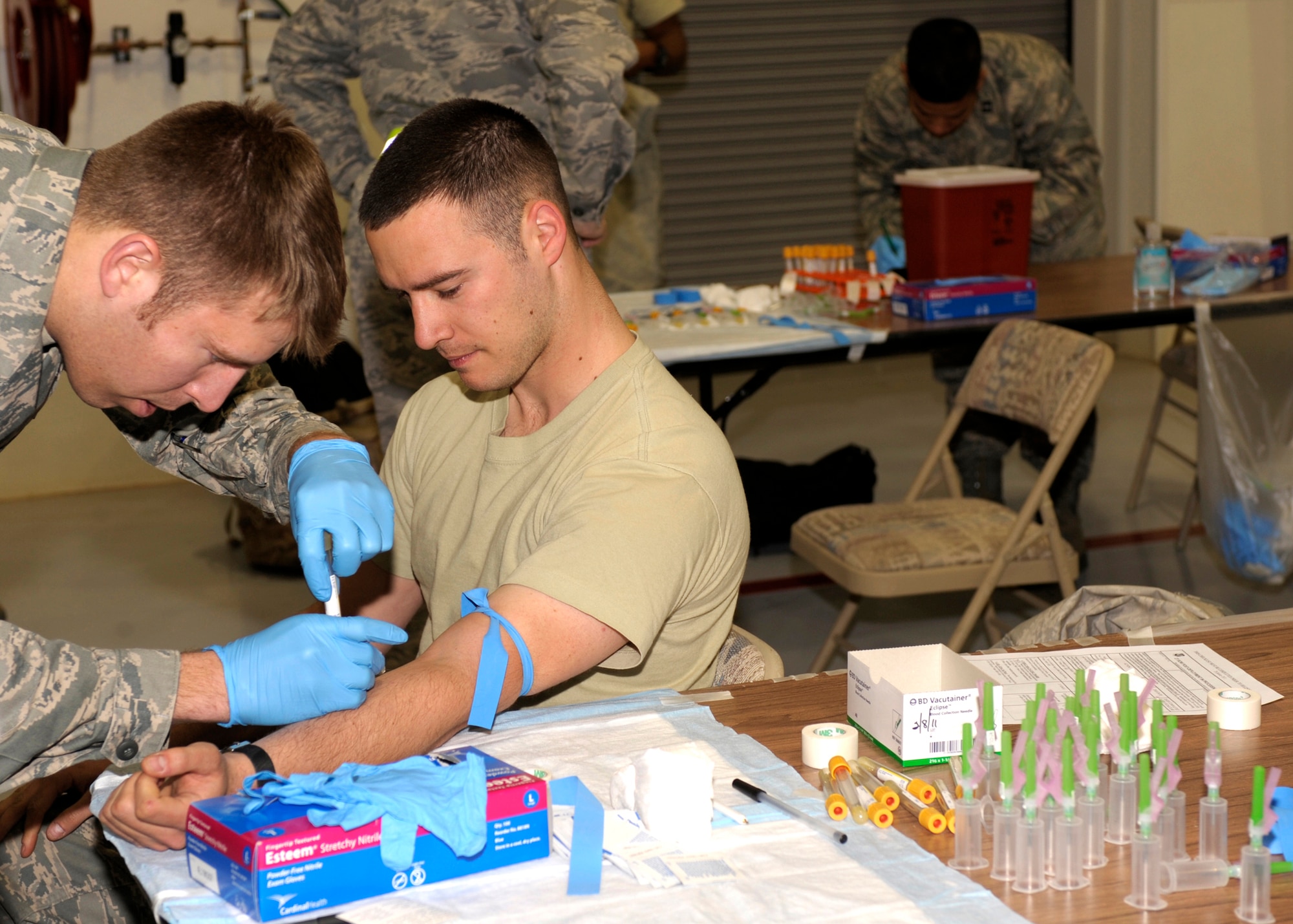 Staff Sgt. Brian Adcock, 27th Special Operations Aircraft Maintenance Squadron, braces himself to get his blood drawn by Airman 1st Class Drew Bivens, 27th Special Operations Aerospace Medicine Squadron, following his return from deployment to Cannon Air Force Base, N.M.,March 9, 2011. Blood is drawn from returning Air Commandos as a precautionary health measure following a deployment.  (U.S. Air Force photo by Airman Ericka Engblom)