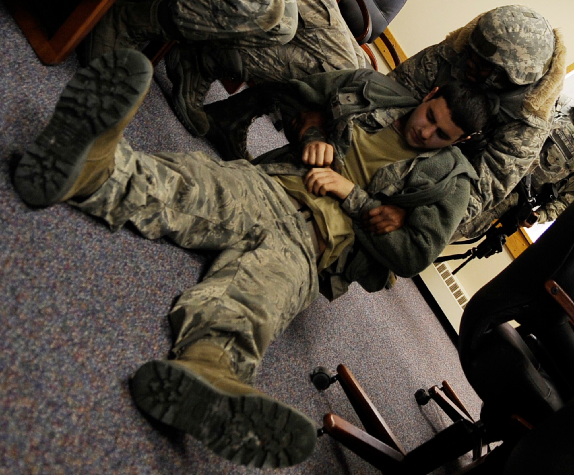 Security Forces Airmen relocate victims into a makeshift triage room during an operational readiness exercise March 9, 2011 Eielson Air Force Base, Alaska. The exercise is designed to give Airmen experience training in a simulated heightened environment. (U.S. Air Force photo/Airman 1st Class Laura Goodgame)