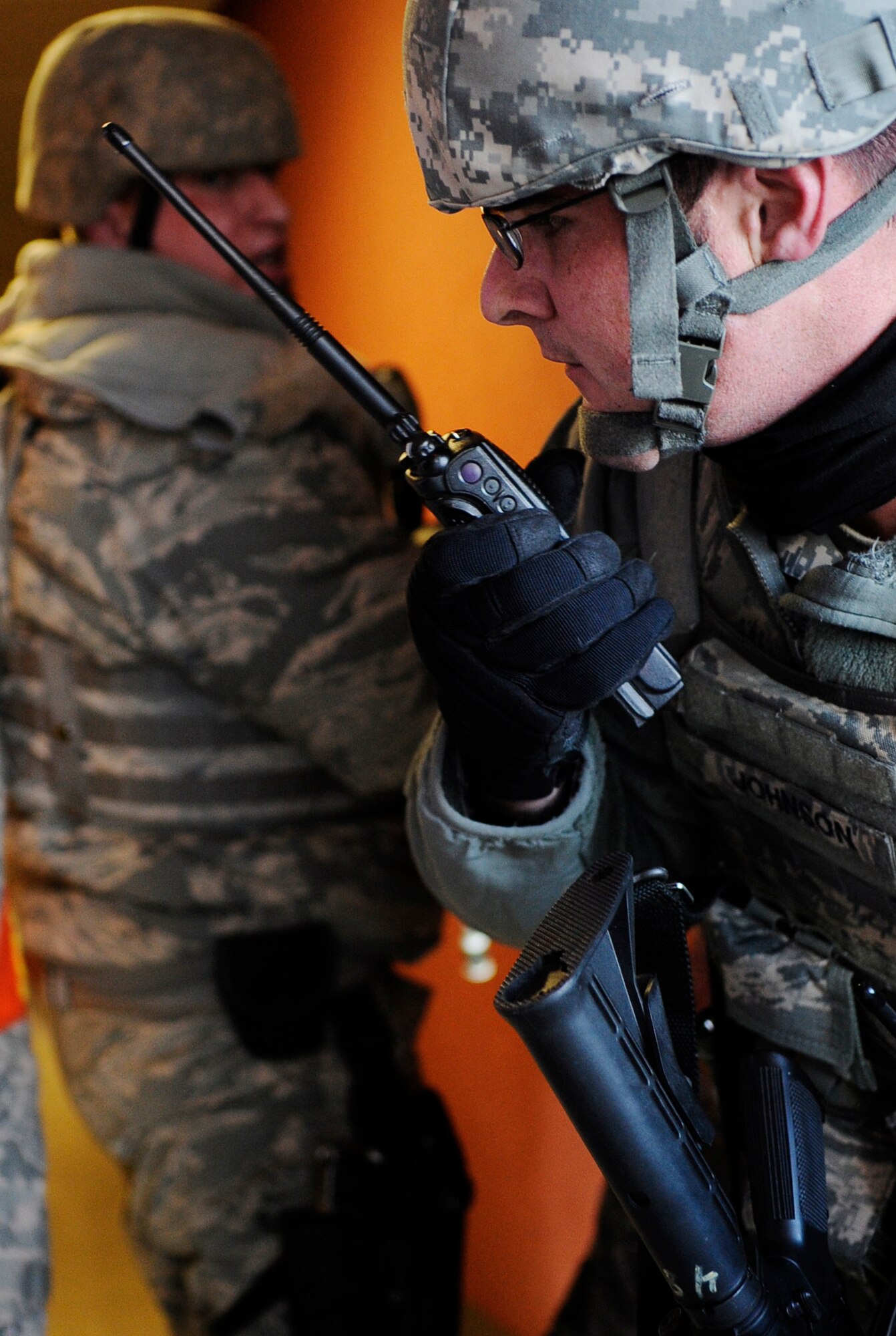Staff Sgt. Adam Johnson and Senior Airman Kevin Kodat listen to radio communications during an operational readiness exercise March 9, 2011 Eielson Air Force Base, Alaska. The exercise is designed to give Airmen experience training in a simulated heightened threat environment. Sergeant Johnson and Airman Kodat are assigned to the 354th Security Forces Squadron. (U.S. Air Force photo/Airman 1st Class Laura Goodgame)