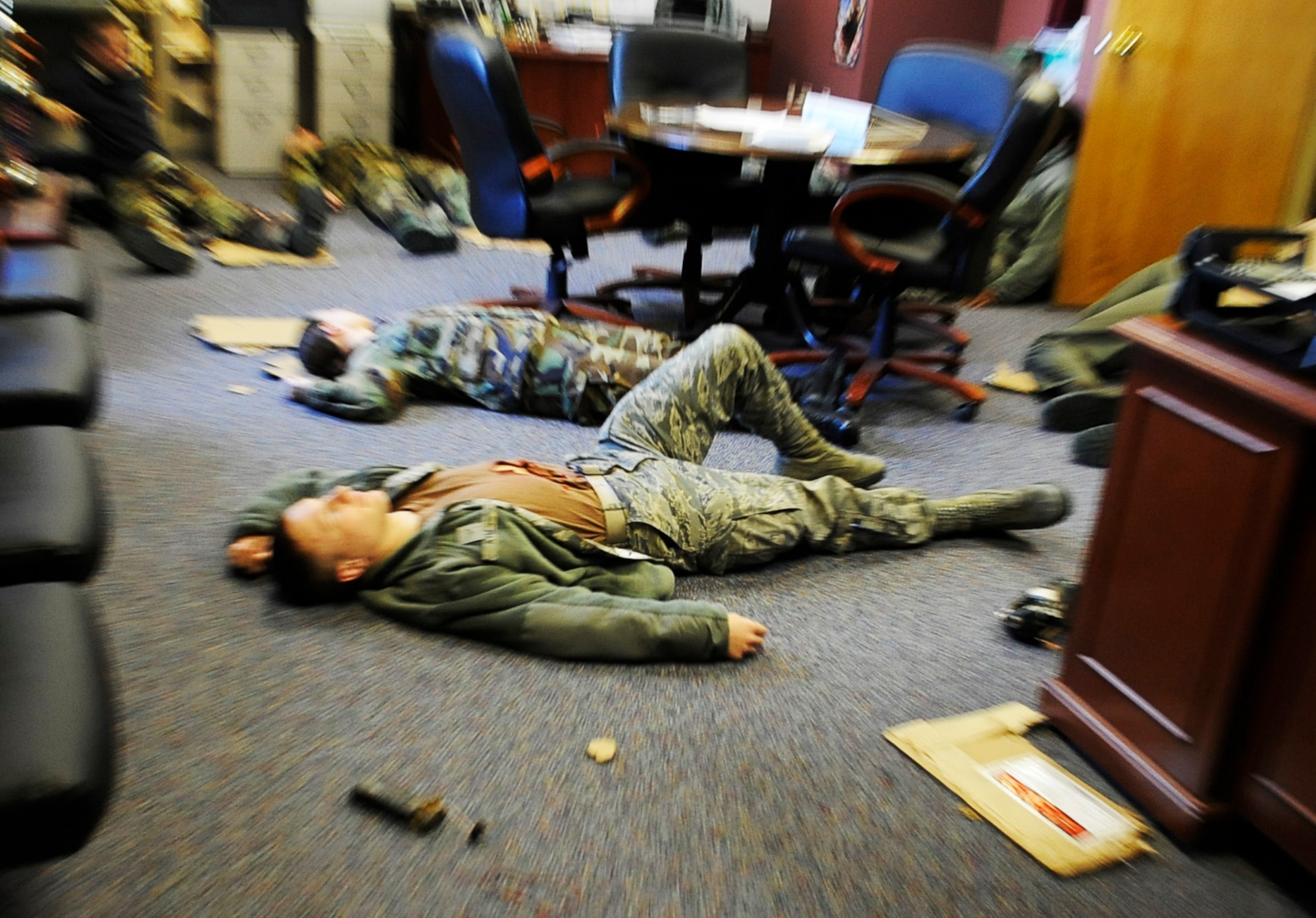 Airmen lay scattered around an office after a simulated blast during an operational readiness exercise March 9, 2011 Eielson Air Force Base, Alaska. The exercise is designed to give Airmen experience training in a simulated heightened threat environment. (U.S. Air Force photo/Airman 1st Class Laura Goodgame)