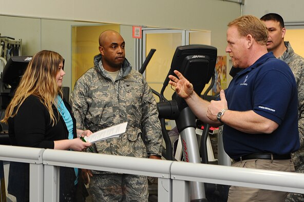 (Right) Retired Chief Master Sgt. Rick Ives, 28th Force Support Squadron fitness center director, explains upcoming changes at the Bellamy Fitness Center to Col. Trent Edwards, 28th Mission Support Group commander, and Mandy Morford, monitor of the spouses’ Facebook page at Ellsworth Air Force Base, March 01, 2011. Mrs. Morford spent the day shadowing Colonel Edwards as he answered questions from the spouses’ group on base. (U.S. Air Force photo/Senior Airman Kasey Close)