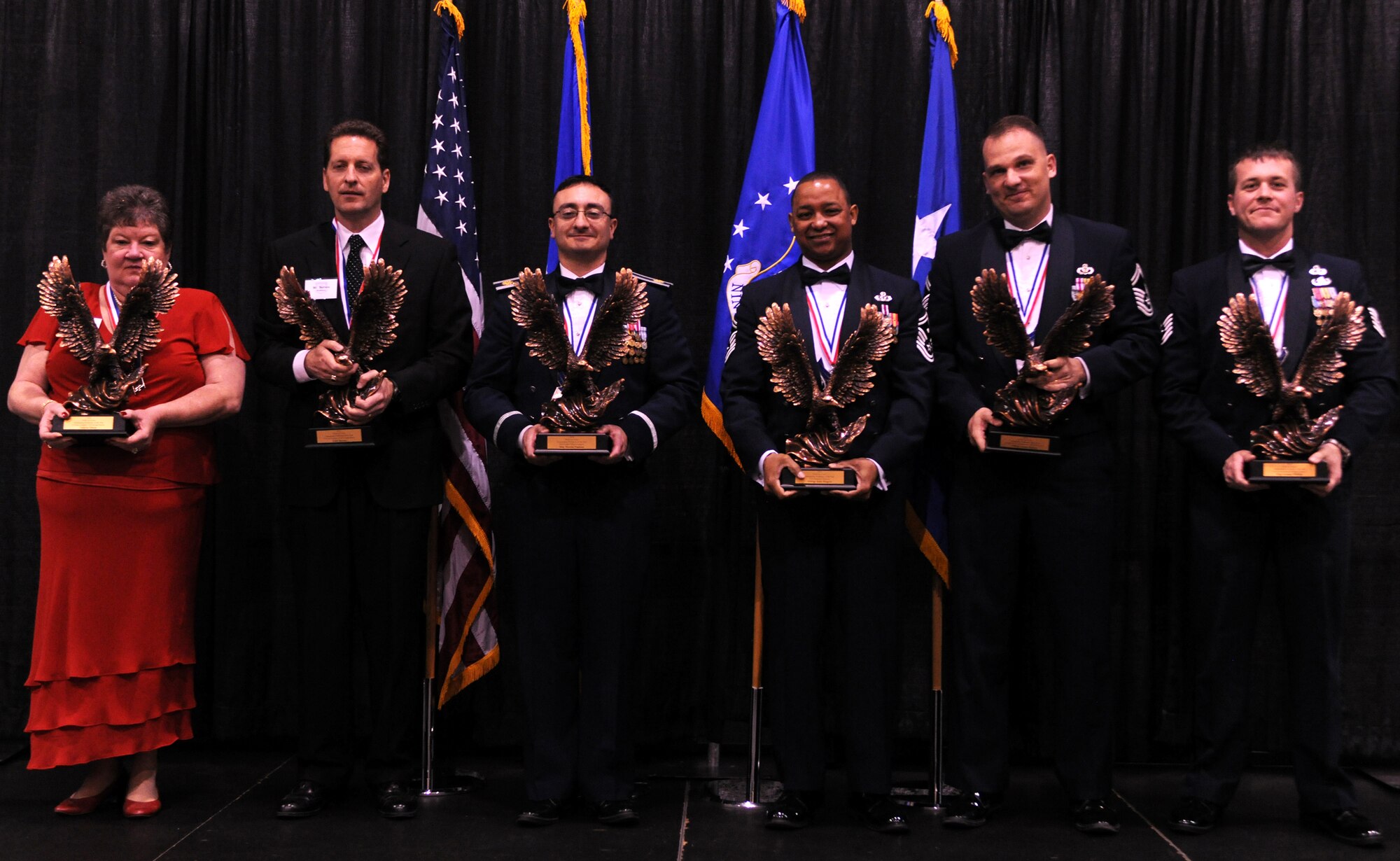 VALDOSTA, Ga.-- The Outstanding Performers of the Year award winners pose for a photo as the OPY awards ceremony comes to a close at the James H. Rainwater Conference Center in Valdosta, Ga., March 10. Hard work and determination were the key factors in making these nominees excel over the competition to win OPY honors for their respectable wings. (U.S. Air Force photo/Airman 1st Class Benjamin Wiseman)(RELEASED)