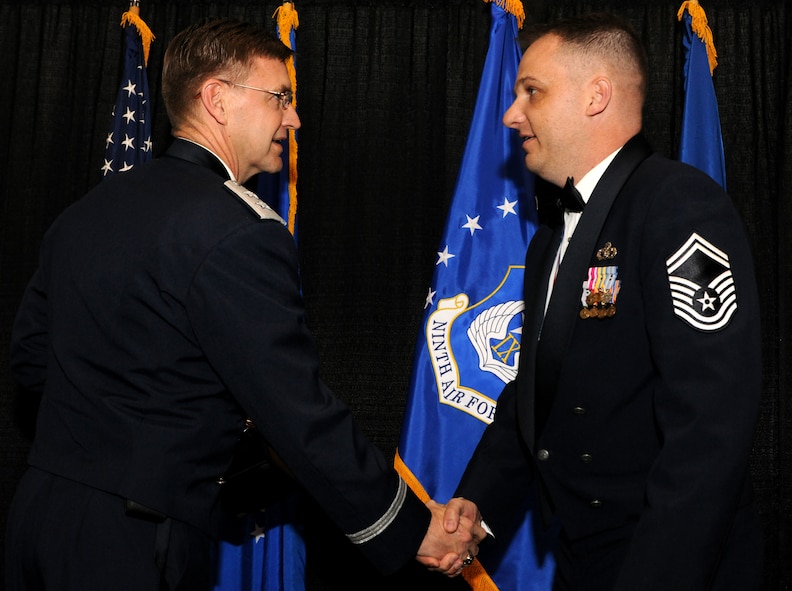VALDOSTA, Ga.-- Senior Master Sgt. James Purkey, Outstanding Performer of the Year in the senior NCO category from the 4th Fighter Wing, Seymour Johnson Air Force Base, N.C., shakes hands with Maj. Gen. Stephen Hoog, 9th Air Force commander, after he was named as the winner in his category during the OPY awards ceremony held at the James H. Rainwater Conference Center in Valdosta, Ga., March 10. General Hoog presented each winner with a trophy and a congratulatory hand shake. (U.S. Air Force photo/Airman 1st Class Benjamin Wiseman)(RELEASED)
