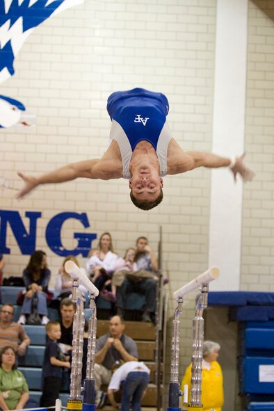 Air Force Academy Cadet senior Matt Thorne seems to hang mid-air while performing on the parallel bars during a gymnastics competition. The Academy Men's gymnastics Team will hold a team competition against Springfield College at Blake Arena, Springfield College, on March 13 at 1 p.m. They return to Blake Arena March 25 at 7 p.m. for the U.S.A. Gymnastics Championships. The championship finals occur the following day, March 26, at 7 p.m., also at Blake Arena. (US Air Force photo/courtesy photo)