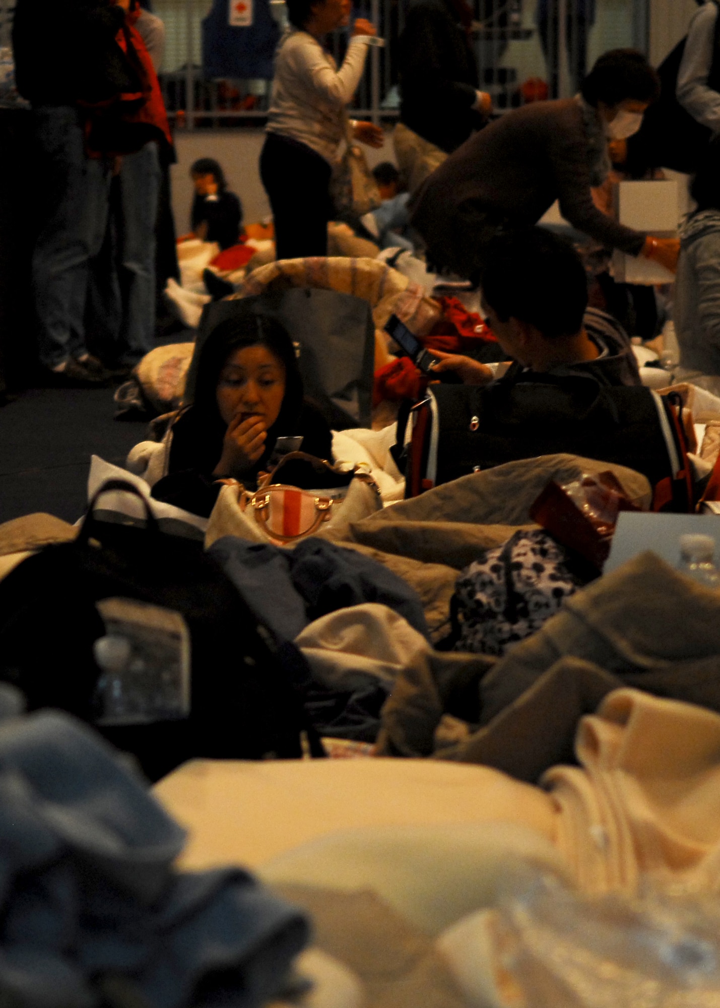 YOKOTA AIR BASE, Japan -- Delta Airlines passengers rest inside the Taiyo Community Center here March 11. The base provided food and lodging for airline passengers diverted from Narita International Airport, Tokyo, Japan, after an earthquake struck near Tokyo. (U.S. Air Force photo/Airman 1st Class Andrea Salazar)
