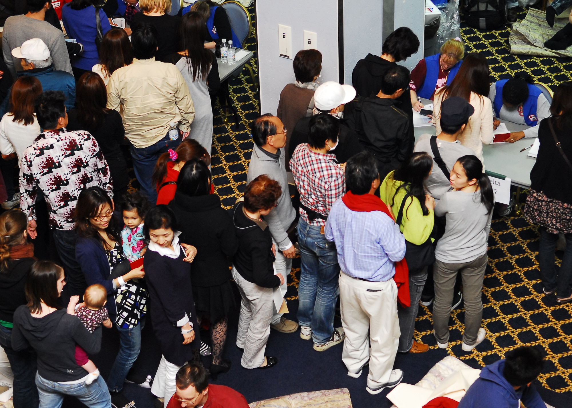 YOKOTA AIR BASE, Japan -- American Red Cross volunteers take accountability of Delta Airline passengers here March 11. The Taiyo Community Center offered food and shelter to aircraft diverted from Narita International Airport, Tokyo, Japan, after an earthquake near Tokyo. (U.S. Air Force photo/Airman 1st Class Andrea Salazar)
