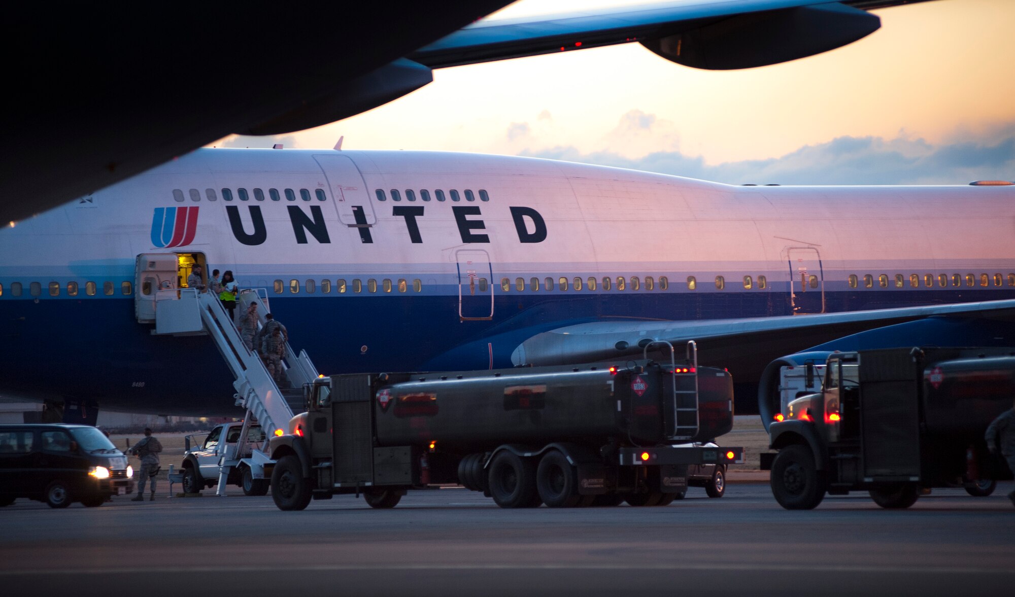 YOKOTA AIR BASE, Japan -- Passengers exit a United Airlines flight here March 11, after diverting from Narita International Airport, Tokyo, Japan. The base opened its airfield to commercial aircraft after an earthquake struck near Tokyo. (U.S. Air Force photo/Staff Sgt. Samuel Morse)