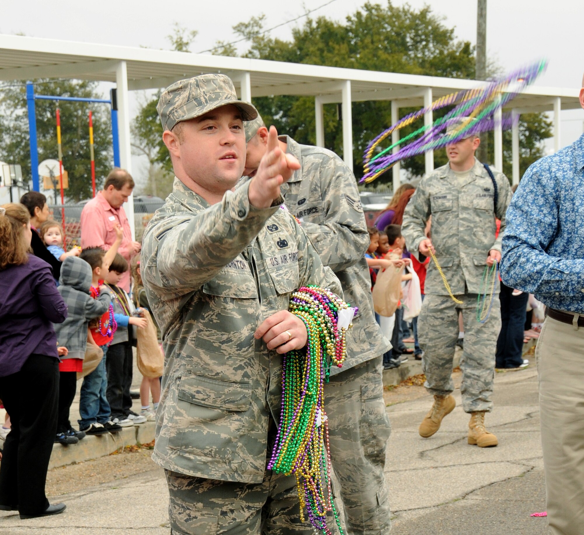 “Laissez les bon temps rouler” is French for “Let the good times roll,” a common phrase associated with Mardi Gras, a regional celebration preceding the Lenten season. Staff Sgt. Brian Thornton, Air Force Legal Operations Agency Area Defense Counsel office at Keesler, tosses Mardi Gras beads to children at Friday’s Jeff Davis Elementary School Mardi Gras parade in Biloxi. Keesler members participated in many other Mardi Gras parades and balls in the weeks leading up to Mardi Gras Day, Tuesday.  (U.S. Air Force photo by Kemberly Groue)