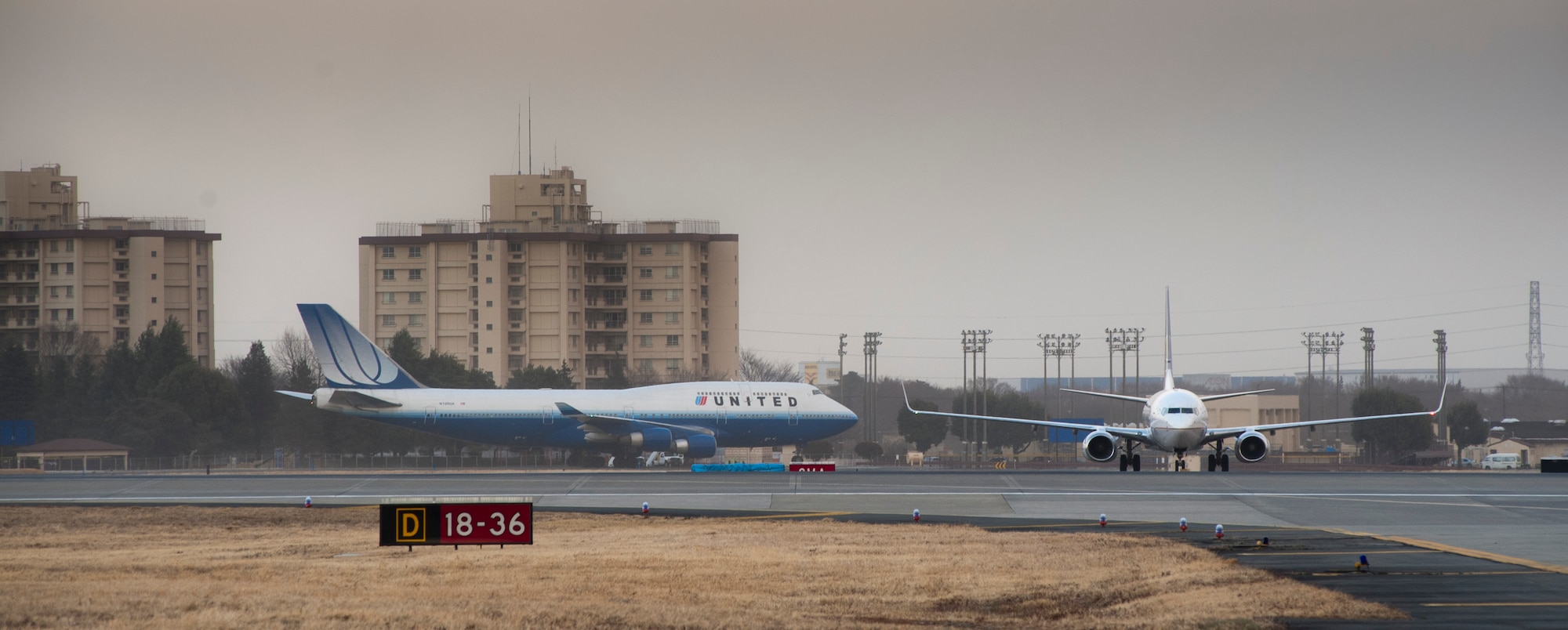YOKOTA AIR BASE, Japan -- Commercial aircraft land on the flightline here March 11, after diverting from Narita International Airport, Tokyo, Japan. The base opened its airfield to commercial aircraft after an earthquake hit near Tokyo. (U.S. Air Force photo/Staff Sgt. Samuel Morse)