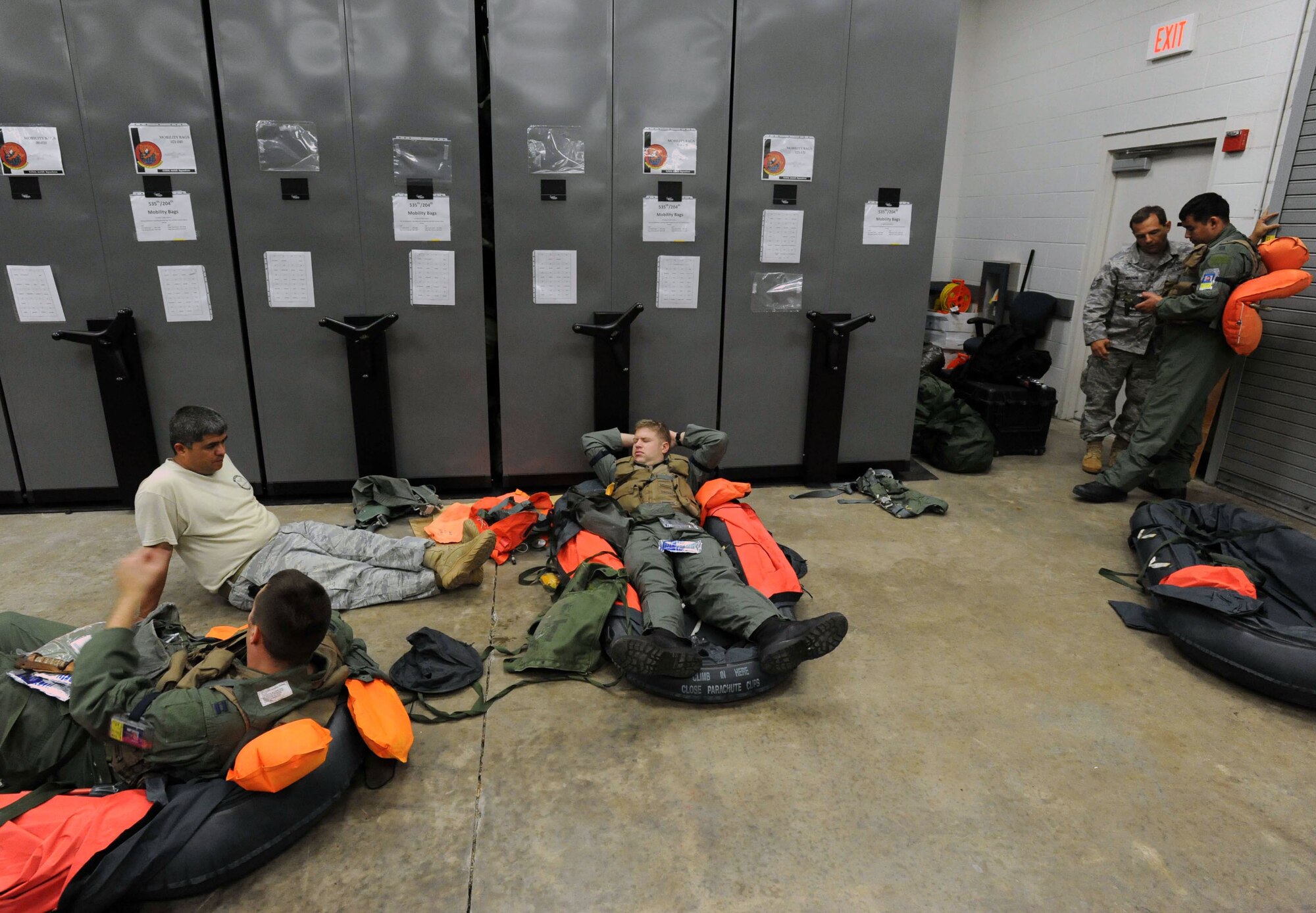 Aircrew members (in flightsuits) and survival, evasion, resistance, and escape specialists (in Airman Battle Uniforms) review water survival skills during an Operational Readiness Exercise Mar. 4 at Joint Base Pearl Harbor Hickam. The ORE tested Airmen's ability to respond to survive and operate during various wartime conditions. (U.S. Air Force photo/Staff Sgt. Nathan Allen)