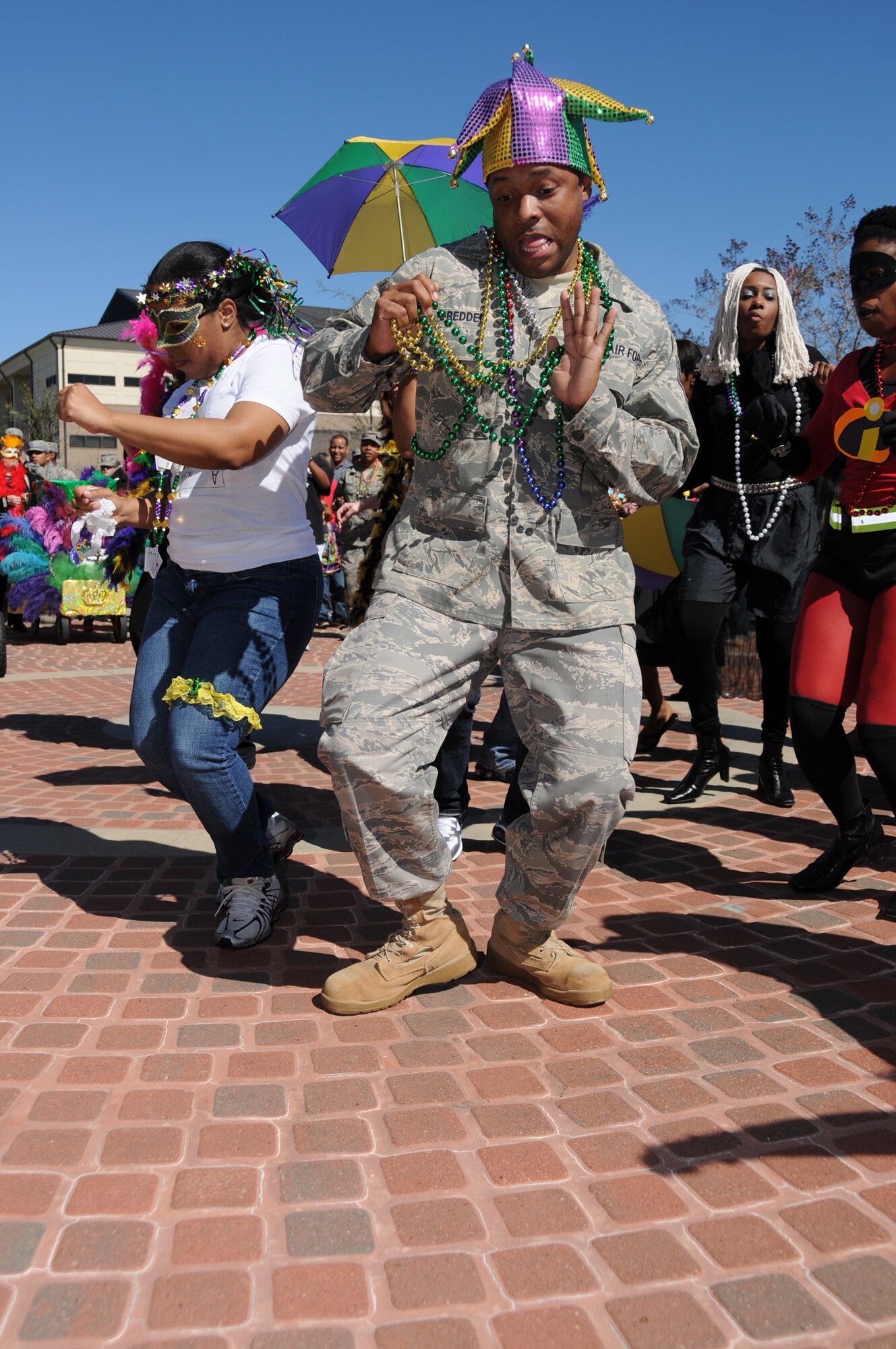 Tech. Sgt. Joanne Simmons, left, and Staff Sgt. Douglas Dredden dance at the 336th Training Squadron’s Mardi Gras celebration.  The event, complete with floats and costumes, followed a hail-andfarewell luncheon March 1.  (U.S. Air Force photo by Kemberly Groue)