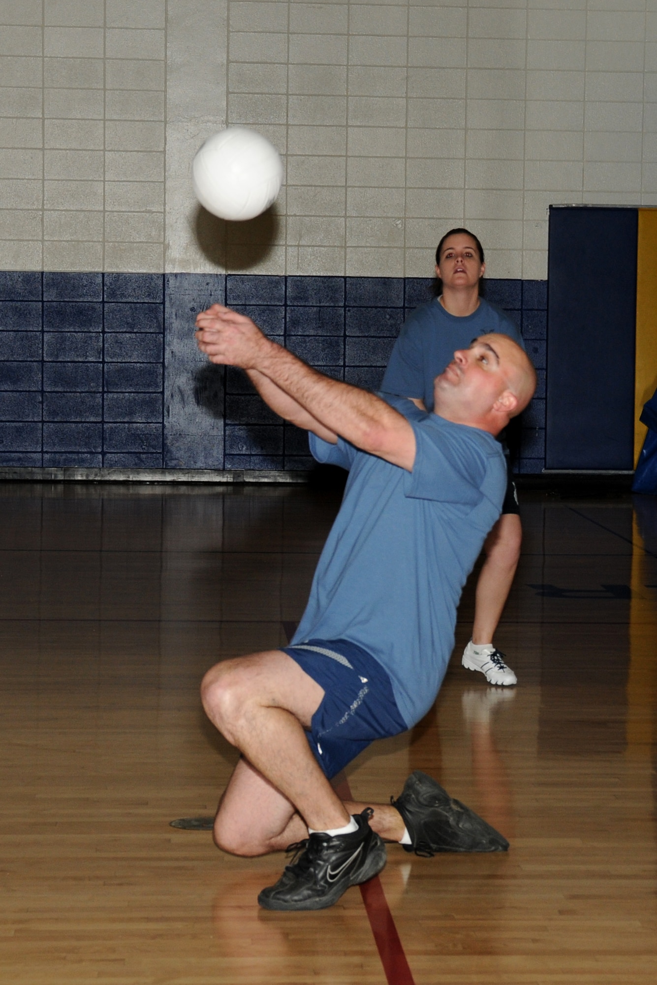 Michael Asdel rturns a serve for the 81st Security Forces Squadron as teammate Lamanda Parker stands by during a Western Conference intramural volleyball contest with the 81st Medical Operations Squadron March 3.  The medics won, 2-0.  (U.S. Air Force photos by Kemberly Groue)