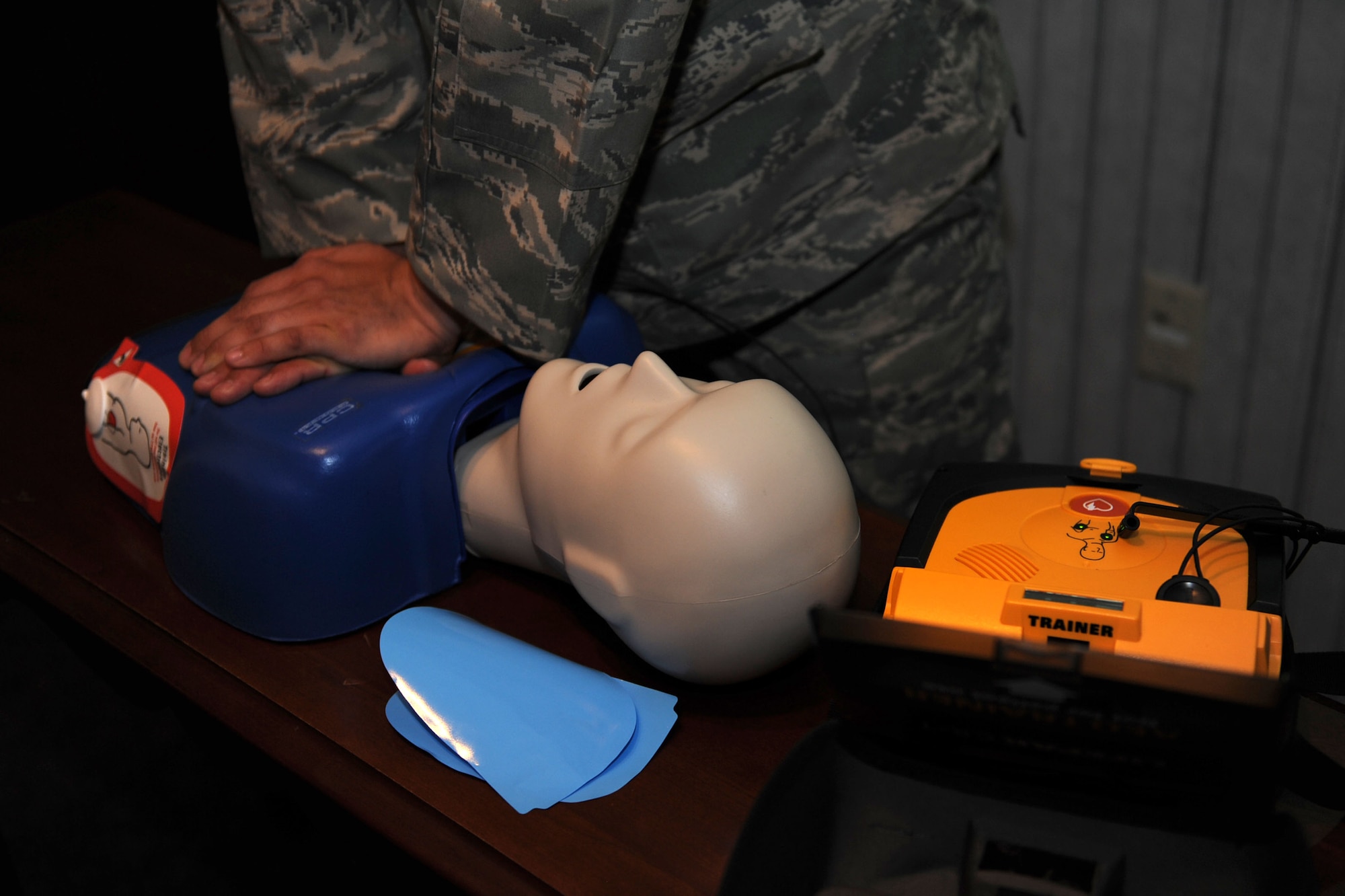 3/9/2011 - NELLIS AIR FORCE BASE, Nev. -- 1st Lt. Mario Sauceda, a member of the 99th Air Base Wing Commanders Action Group, demonstrates how to use an Automated External Defibrillator during the 99th ABW weekly staff meeting March 9th.  The Public Access Defibrillation program members are trying to raise awareness about the AED device and can assist units in obtaining the device.  For more information, contact DeAndre.Scott@nellis.af.mil or Cheryl.Hulsman@nellis.af.mil.  (U.S. Air Force photo by Staff Sgt. Taylor Worley)
