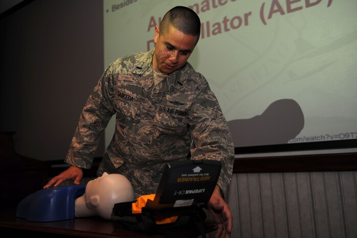 3/9/2011 - NELLIS AIR FORCE BASE, Nev. -- 1st Lt. Mario Sauceda, a member of the 99th Air Base Wing Commanders Action Group, demonstrates how to use an Automated External Defibrillator during the 99th ABW weekly staff meeting March 9th.  The Public Access Defibrillation program members are trying to raise awareness about the AED device and can assist units in obtaining the device.  For more information, contact DeAndre.Scott@nellis.af.mil or Cheryl.Hulsman@nellis.af.mil.(U.S. Air Force photo by Staff Sgt. Taylor Worley)