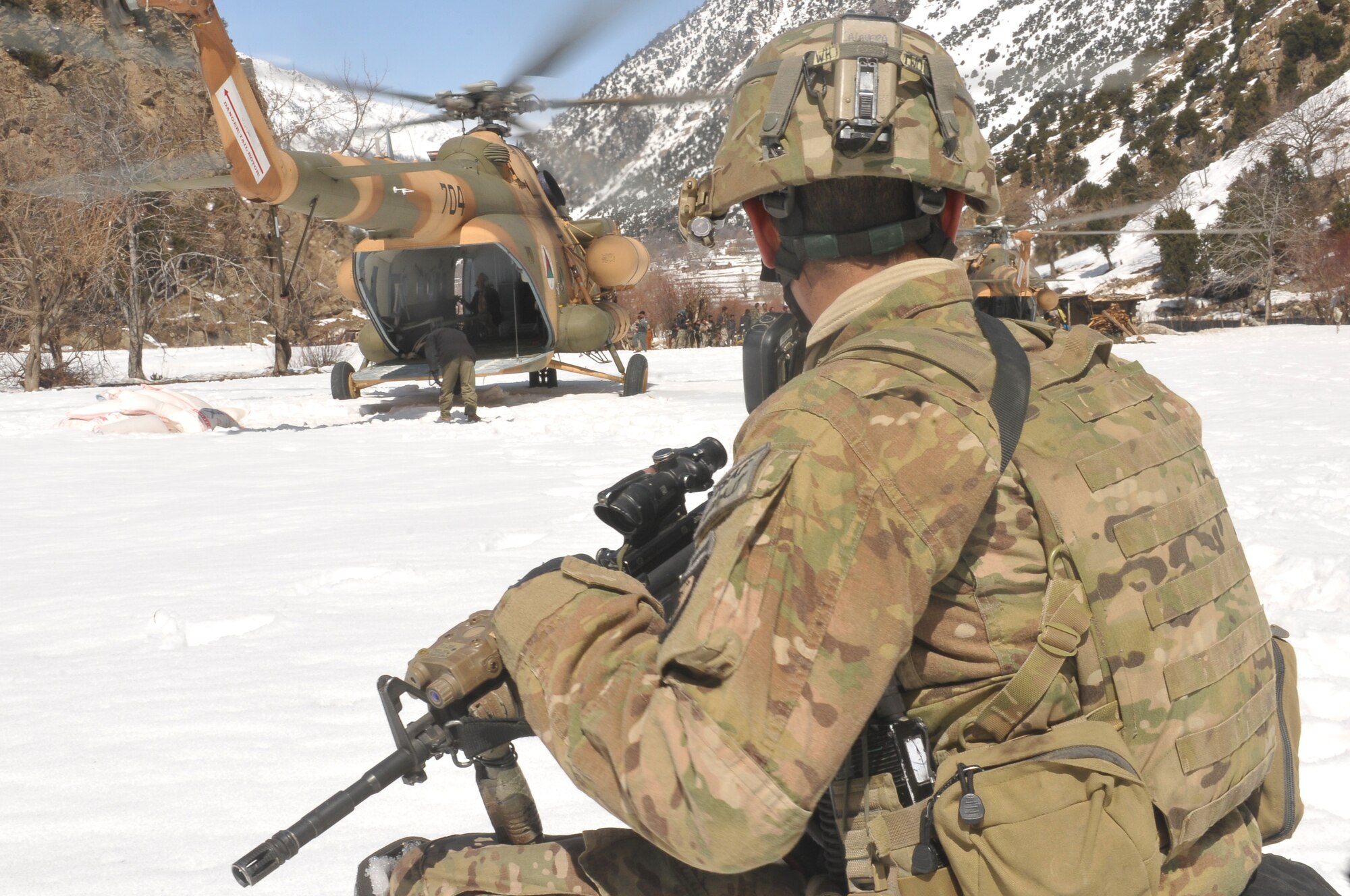 Barge Matal, Afghanistan – A U.S. Army soldier provides security watch during a combat resupply mission in Barge Matal in the northern Kunar Valley March 10. The Afghan Air Force worked in cooperation with the Ministry of the Interior and coalition forces to complete the mission, using ten aircraft to deliver over 9,000 kilograms of weapons, ammunition and food to Afghan National Police stationed in the remote post that is seen as vital by Afghan officials due to its proximity to Pakistan and history of insurgent activity. Following the supply drop-off, forces loaded over 80 ANP bound for their respective homes following a three to six month deployment to the region. (U.S. Navy photo by Mass Communications Specialist 2nd Class Vladimir Potapenko).