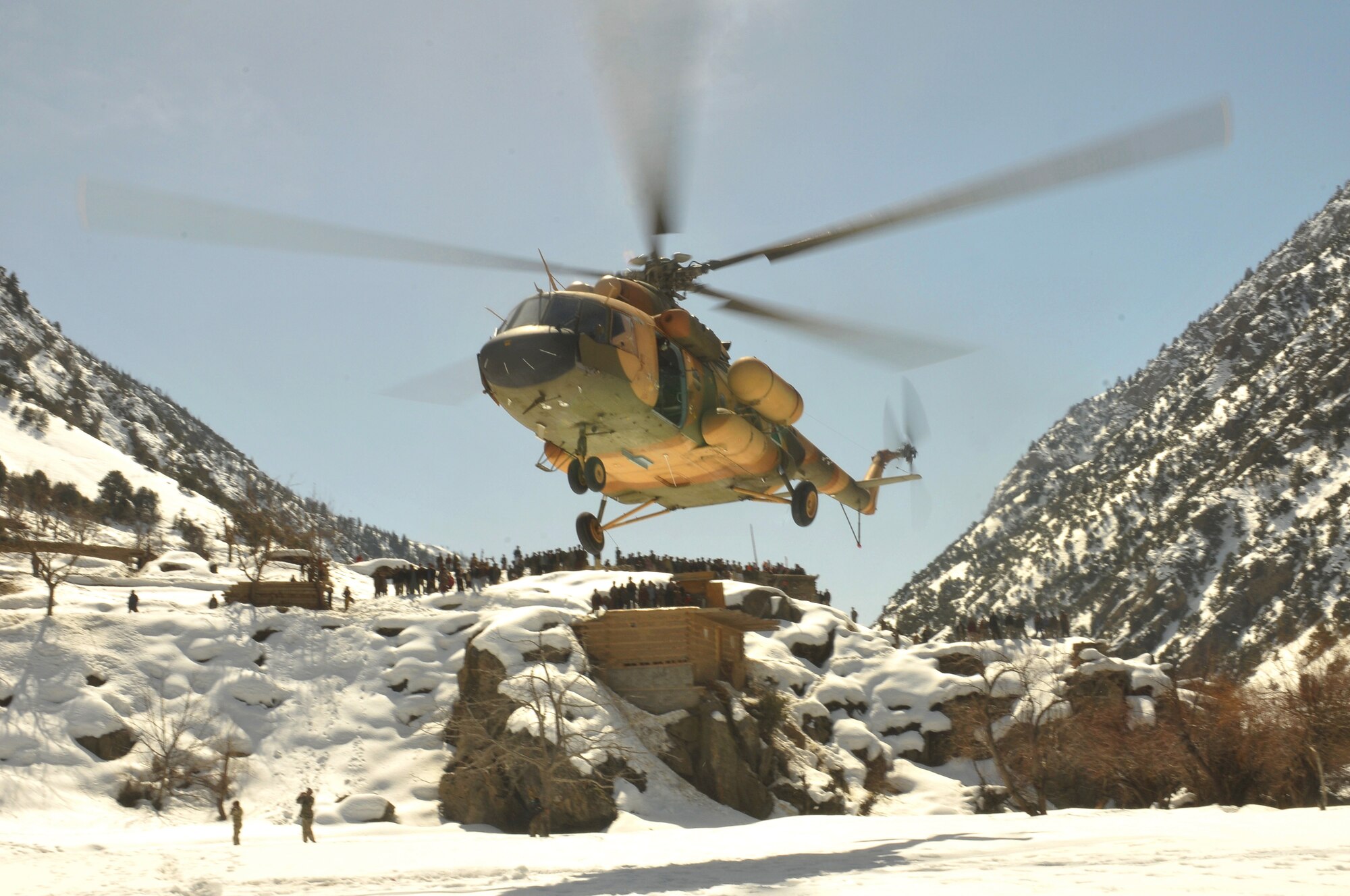 Barge Matal, Afghanistan – An Afghan Air Force Mi-17 transport helicopter descends for a landing during a combat resupply mission in Barge Matal in the northern Kunar Valley March 10. The AAF worked in cooperation with the Ministry of the Interior and coalition forces to complete the mission, using ten aircraft to deliver over 9,000 kilograms of weapons, ammunition and food to Afghan National Police stationed in the remote post that is seen as vital by Afghan officials due to its proximity to Pakistan and history of insurgent activity. Following the supply drop-off, forces loaded over 80 ANP bound for their respective homes following a three to six month deployment to the region. (U.S. Navy photo by Mass Communications Specialist 2nd Class Vladimir Potapenko).