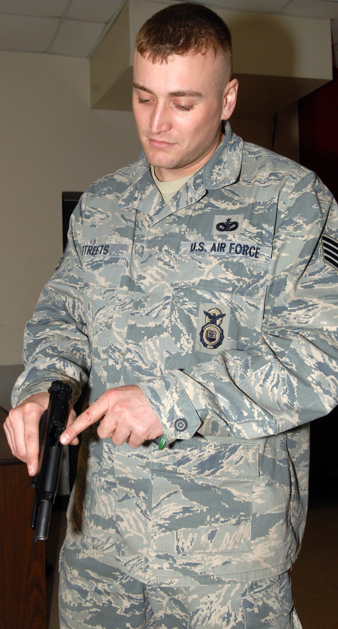 Staff Sgt. Tim Streets, 436th Security Forces Squadron combat arms instructor, demonstrates how to inspect an M-9 to ensure no round is chambered, March, 4 2011, at the Combat Arms Training and Maintenance facility on Dover Air Force Base, Del. Sergeant Streets’ top tip for weapon safety is treat all weapons as if they are loaded. 