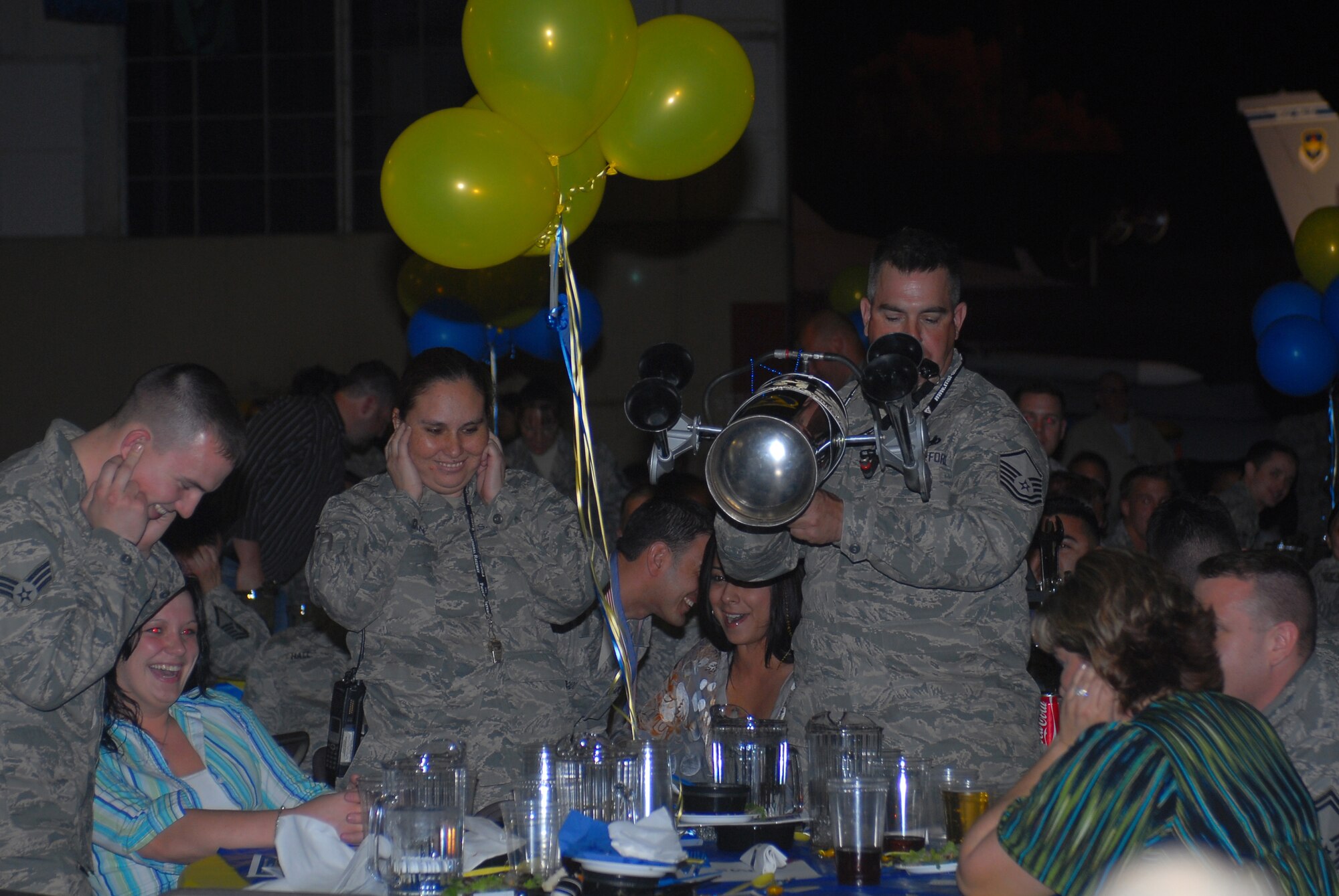 Master Sgt. Erik Gagnon, 56th Equipment Maintenance Squadron aircraft ground equipment repair and inspection assistant NCO-in-charge, blows a horn during the teamwork award competition portion of the maintenance professional of the year banquet.  (U.S. Air Force photo/Senior Airman Tracie Forte)