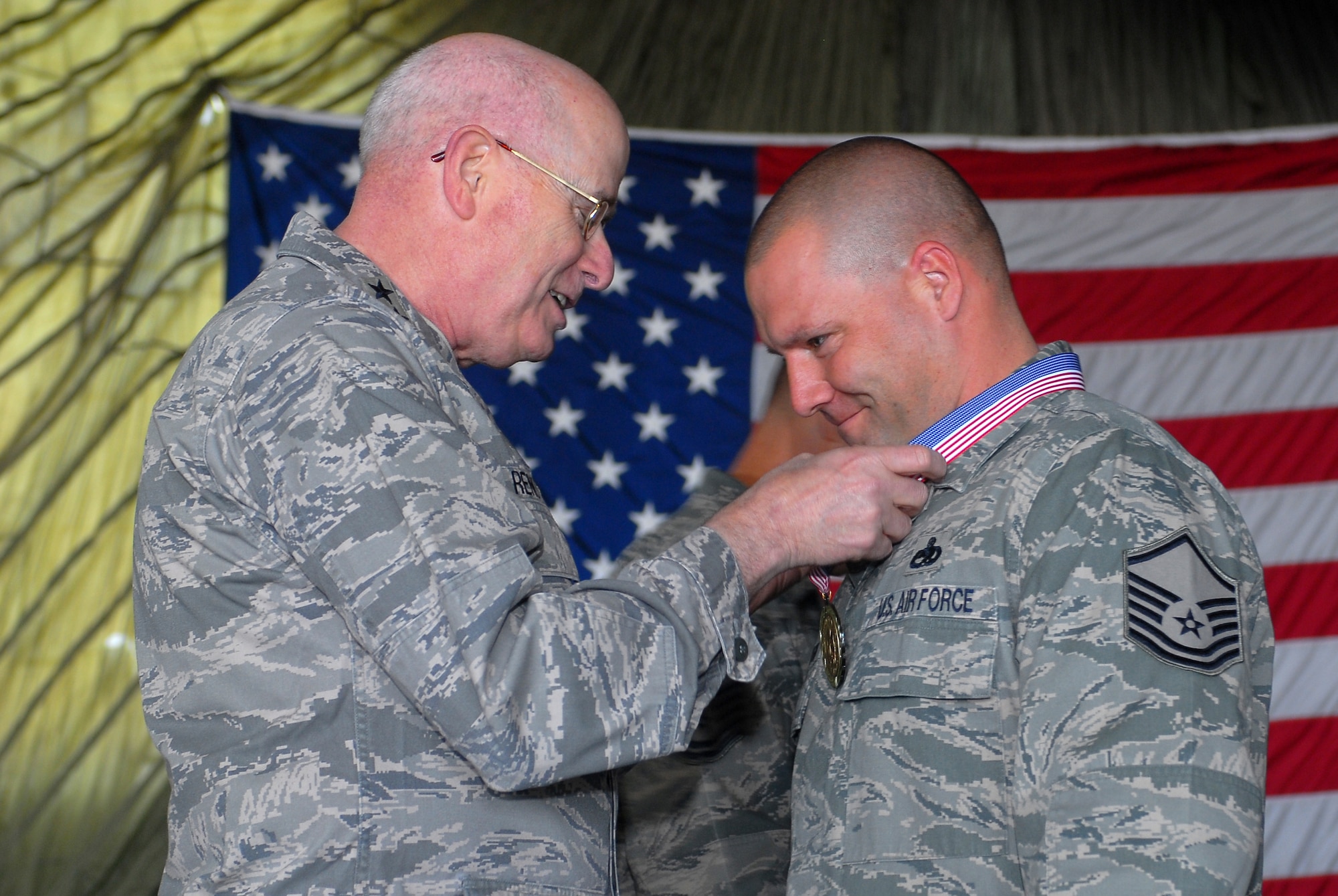 Lt. Gen. Loren Reno, Air Force deputy chief of staff for logistics, installations and mission support, congratulates Master Sgt. Joseph Monthie, a 756th Aircraft Maintenance Squadron production supervisor, on March 5th during a medallion ceremony held before the start of the maintenance professional of the year banquet.  (U.S. Air Force photo/Senior Airman Tracie Forte)