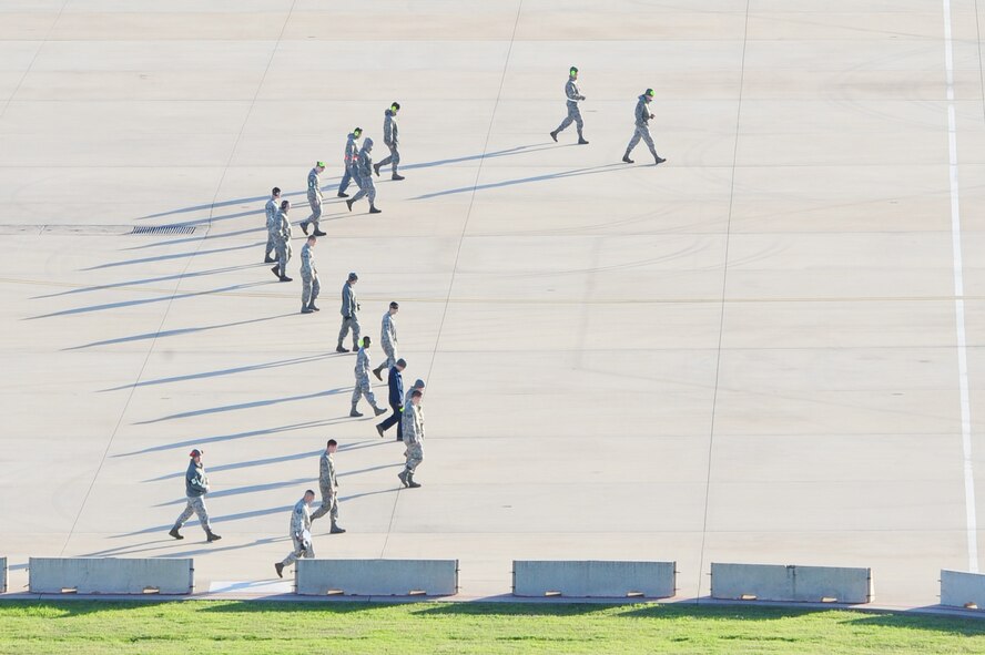Airmen from the 2nd Bomb Wing perform a Foreign Object Damage check on the flight line at Barksdale Air Force Base, La., March 10. A FOD walk is performed to find any objects that can cause damage to aircraft engines. This particular FOD walk was performed in preparation for a Large Force Departure where seven B-52H Stratoforess’ launched within approximately 30 second of each other. (U.S. Air Force photo/Senior Airman Joanna M. Kresge)