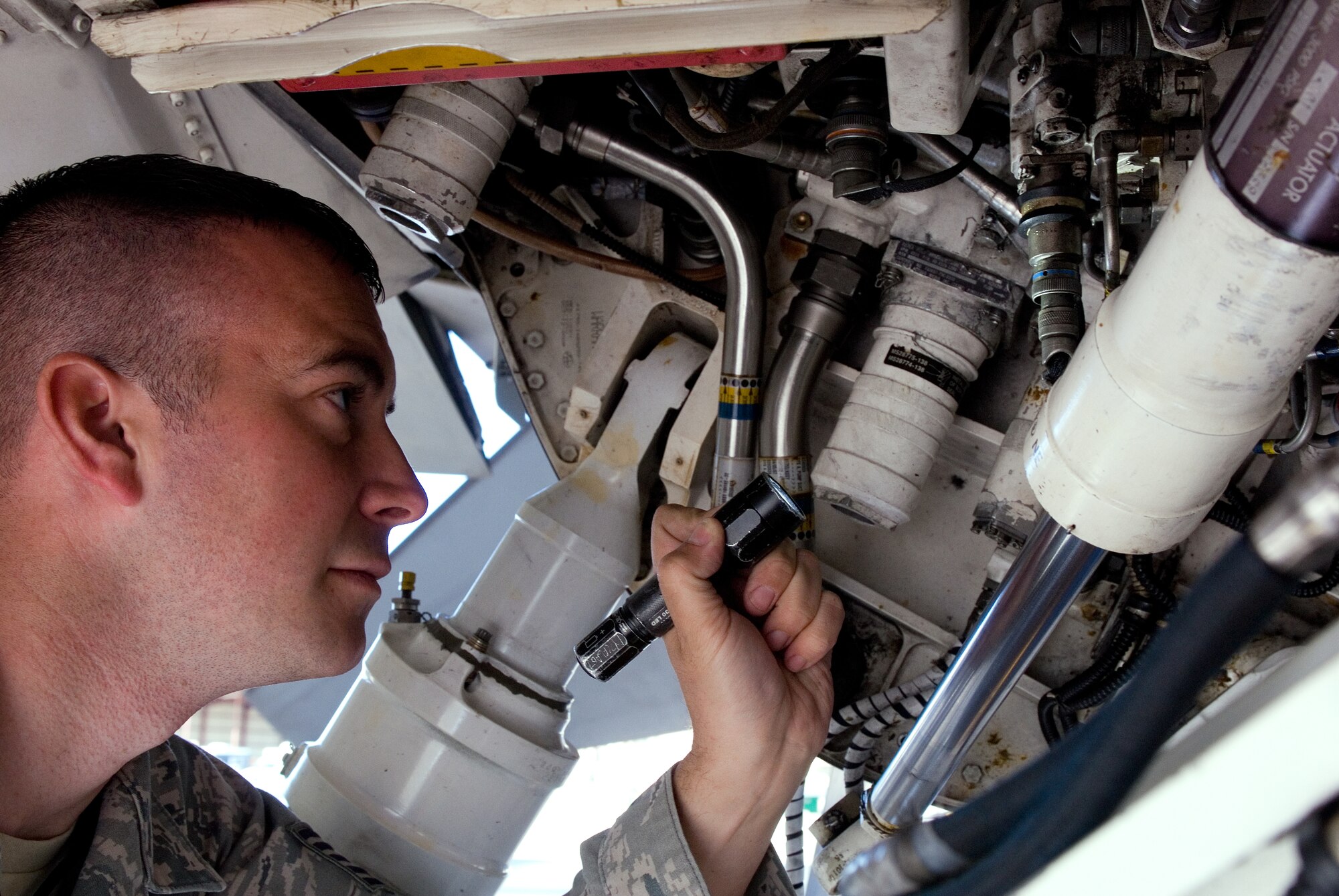Tech. Sgt. Michael Criss, crew chief and instructor at Detachment 12, 372nd Training Squadron, looks for leaks in the hydraulics system of an F-16 Fighting Falcon at Luke Air Force Base.  Sergeant Criss has been an F-16 crew chief for nearly 10 years and was recently selected to join the Air Force Thunderbirds.  (U.S. Air Force photo/Staff Sgt. Jason Colbert)
