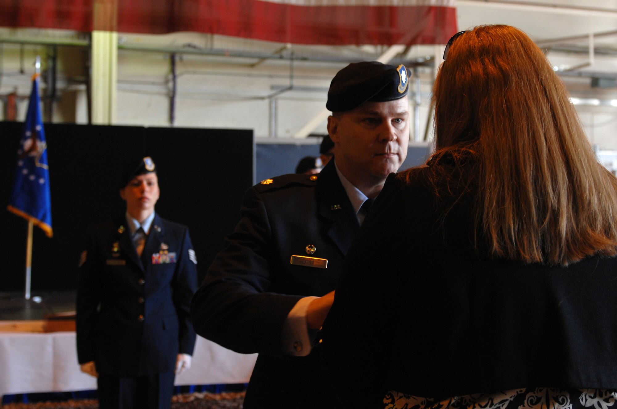 ROYAL AIR FORCE LAKENHEATH, England - Lt. Col. Michael Ross, 48th Security Forces Squadron commander, presents the American flag to Trish Alden, wife of Senior Airman Nicholas J. Alden, a security forces journeyman killed in action during a shooting incident at Frankfurt International Airport, Germany, March 2, 2011, during a memorial service in Hangar 7 on March 11, 2011. More than 500 Airmen, family and friends were in attendance. (U.S. Air Force photo/Tech. Sgt. Lee A. Osberry Jr.)