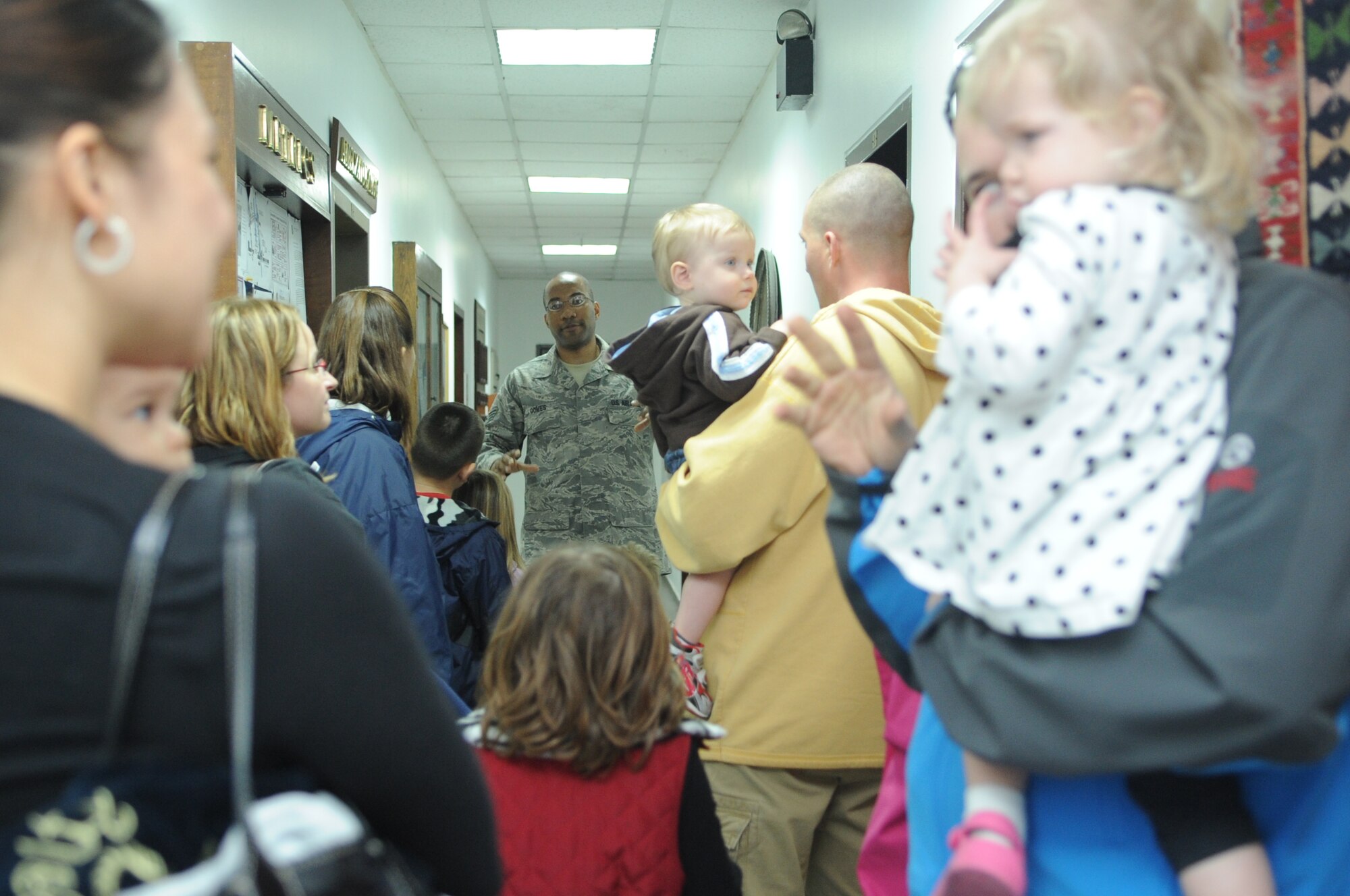 Staff Sgt. George Gomes from the 728th Air Mobility Squadron leads an open house tour Feb. 24, 2011, at Incirlik Air Base, Turkey. The 728th AMS hosted an open house for family members that included a guided tour, demonstrations and briefings by the Airmen of the 728th AMS to help family members understand what the Airmen do at the 728th. (U.S. Air Force photo by Tech. Sgt. Valda Wilson/Released)