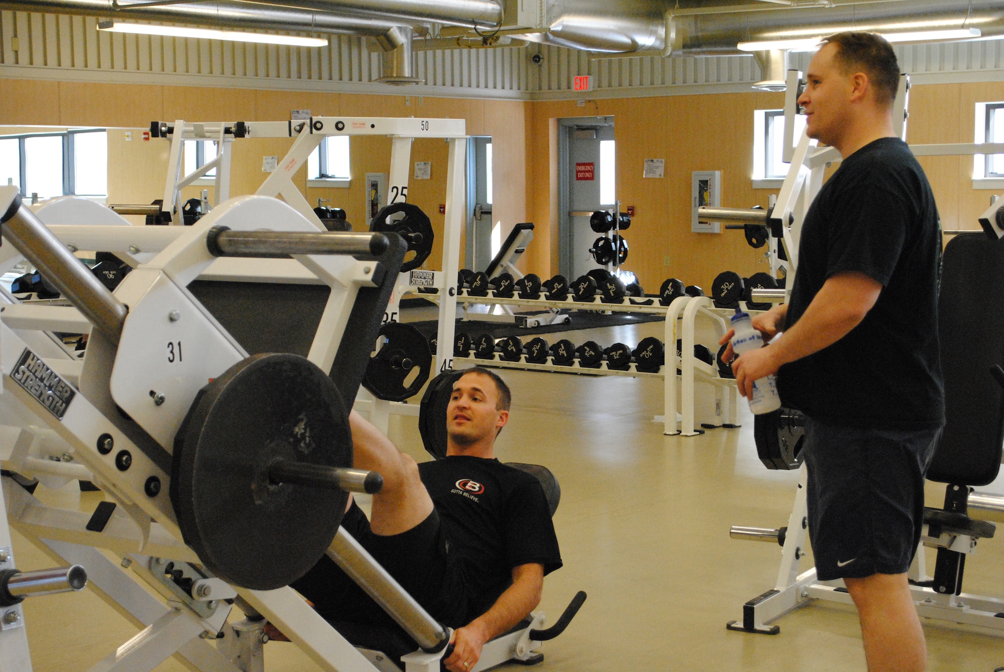 Chris Horn, former NFL wide receiver (left), talks to his partner Lt. Col. David Stephens, the 341st Comptroller Squadron commander, while completing some repititions of leg presses.  As a winner of a drawing, Colonel Stephens got to participate in a work out with Mr. Horn on March 5.  (U.S. Air Force photo/Airman Cortney Hansen)