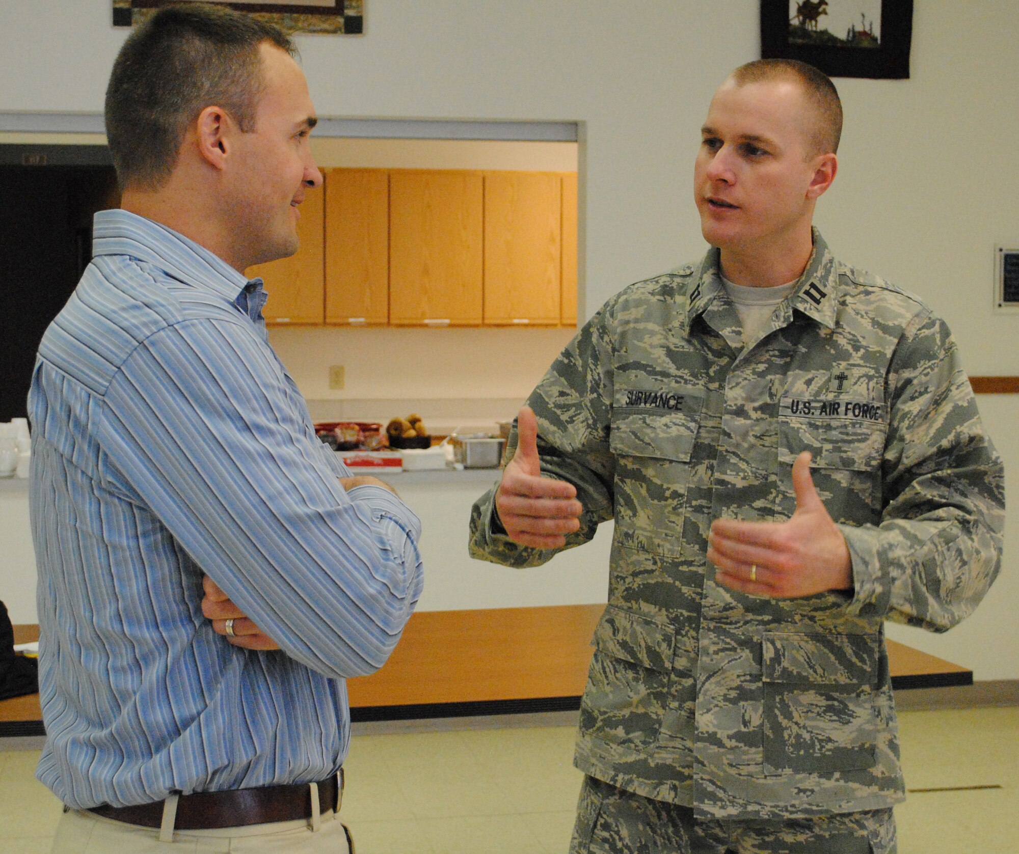 Chris Horn, former NFL wide receiver (left), talks with Chaplain (Capt.) Steven Survance, 341st Missile Wing chaplain, about his "Dare to be Different" presentation.  In his presentation, Mr. Horn described all of the obstacles he had to face chasing his dream to the NFL.  (U.S. Air Force photo/Airman Cortney Hansen)