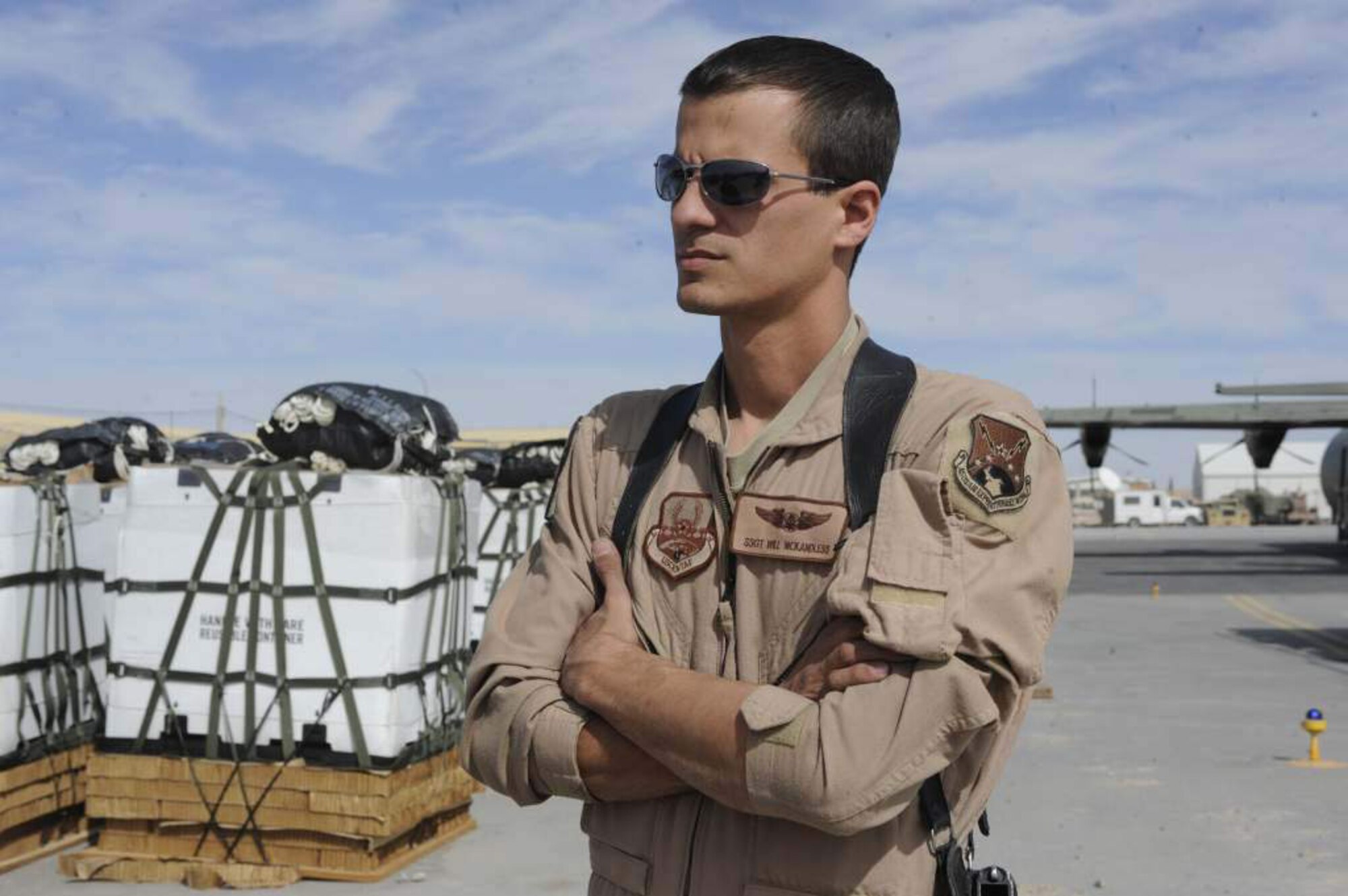 Staff Sgt. William McKandless waits near the runway of Kandahar Airfield Afghanistan, on Feb. 23, 2011, to begin loading a C-130 for a joint airdrop. He is a joint airdrop inspector assigned to the 451st AEW and works with soldiers to deliver supplies to warriors on the ground.