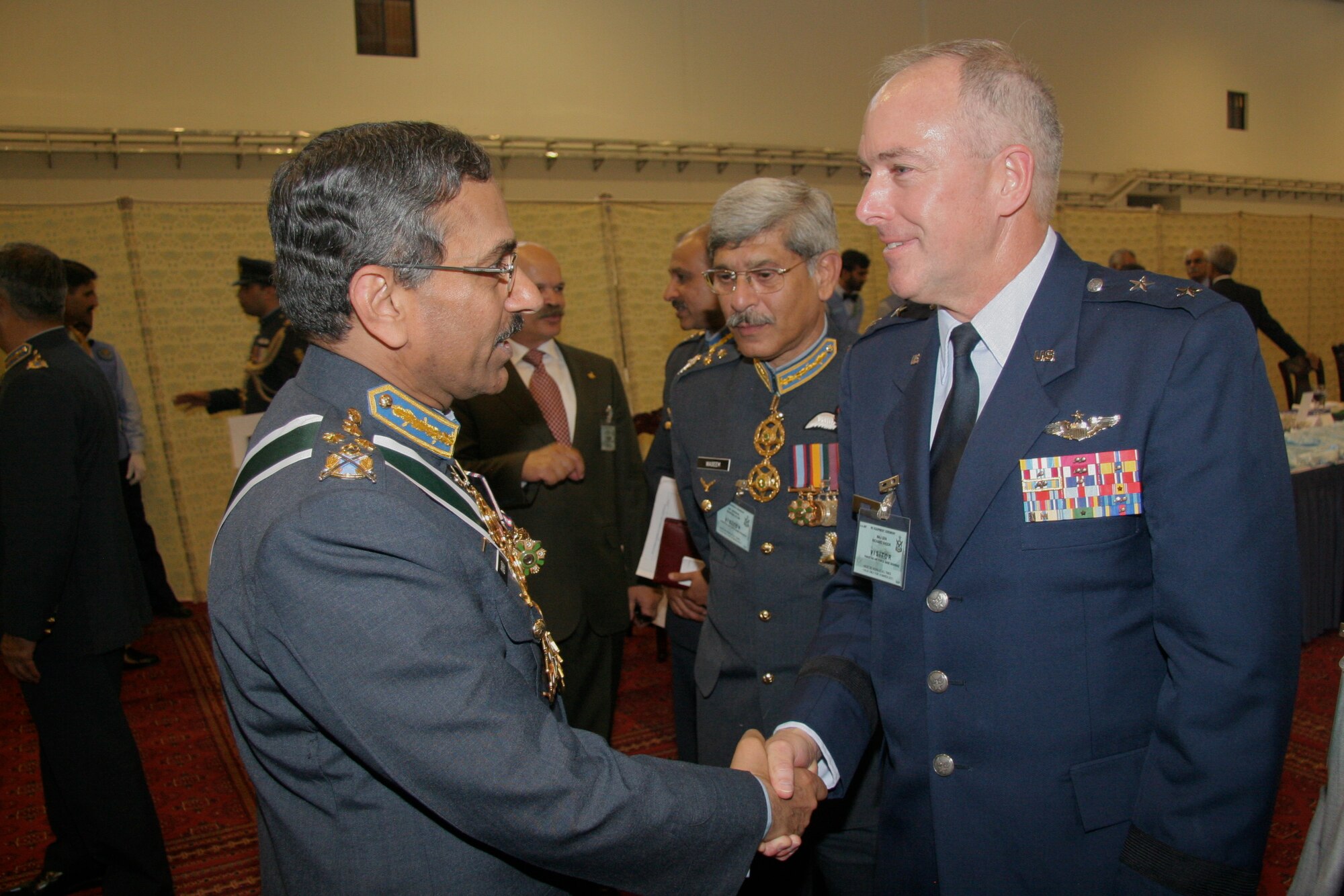 Major General Richard Shook, the Individual Mobilization Augmentee to the Commander of US Air Forces Central Command congratulates Air Chief Marshall Qamar Rao Suleman, Chief of the Air Force Staff.  Both were present on March 10 at Pakistan Air Force Base Shahbaz, in Jacobabad, Pakistan for a re-equipping ceremony in which the Pakistan Air Force formally activated the squadron with 18, F-16 Block 52 aircraft procured from the United States. (U.S. Air Force photo by Lt. Col. Michael Shavers)