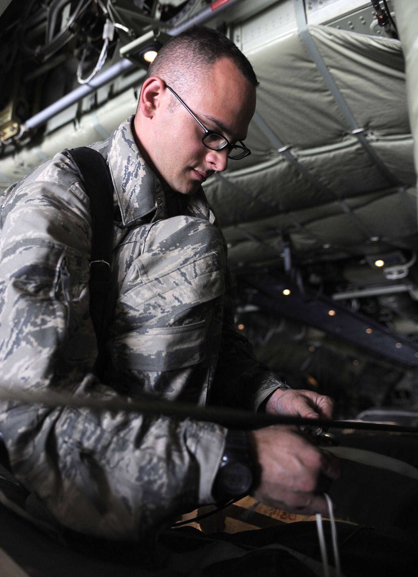 Staff Sgt. Steven Smith ensures the cotter pin is inbound and bent, March 11, 2011, at Kandahar Airfield, Afghanistan. Sergeant Smith inspects bundled cargo to make sure the static lines are properly rigged for break away. Sergeant Smith is a joint airdrop inspector assigned to the 451st Air Expeditionary Wing. (U.S. Air Force photo/Senior Airman Willard E. Grande II/Released)
