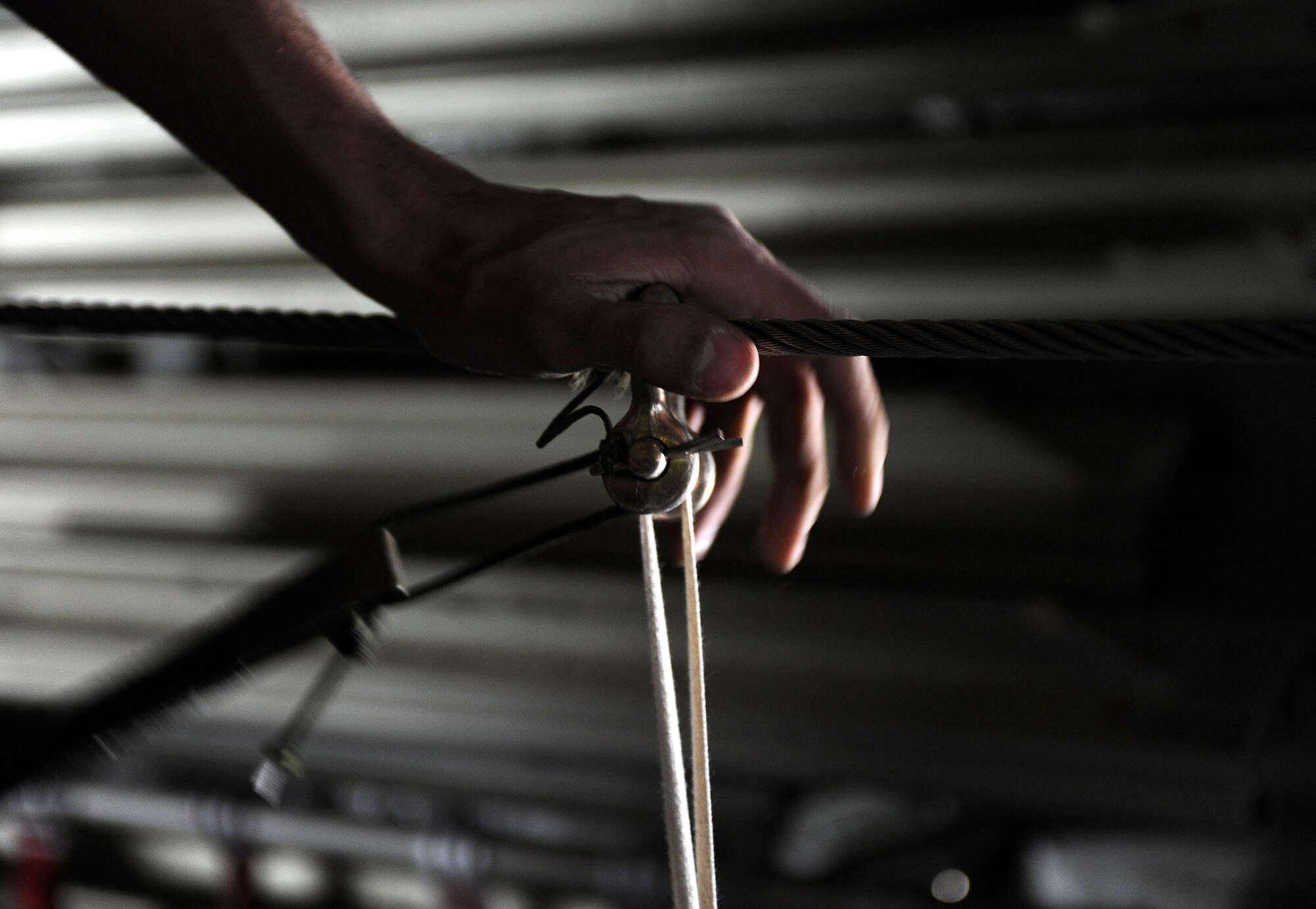 Staff Sgt. William McKandless ensures the cotter pin is inbound and bent, March 11, 2011, at Kandahar Airfield, Afghanistan. Sergeant McKandless inspects bundled cargo to make sure the static lines are properly rigged for break away. Sergeant McKandless is a joint airdrop inspector assigned to the 451st Air Expeditionary Wing. (U.S. Air Force photo/Senior Airman Willard E. Grande II/Released)