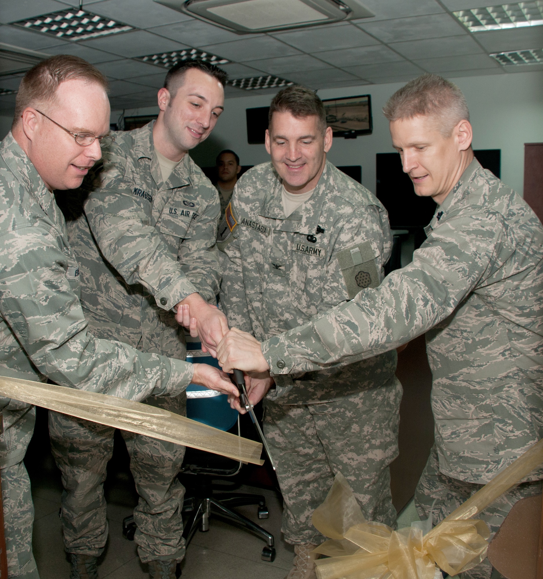 Col. Eric Beene, the 39th Air Base Wing commander, Airman 1st Class Eric Krauesn, from the 728th Air Mobility Squadron, Col. Michael Anastasia, from the Office of Defense Cooperation – Turkey, and the Commander of the728th AMS Lt. Col. Brian Lindsey, participate in a ribbon cutting ceremony for a new communications system March 3, 2011, at Incirlik Air Base, Turkey. The 728th AMS installed a $400,000 communications system that will save time and manpower to complete the mission more efficiently, officials said. (U.S. Air Force photo by Staff Sgt. Alexandre Montes) 