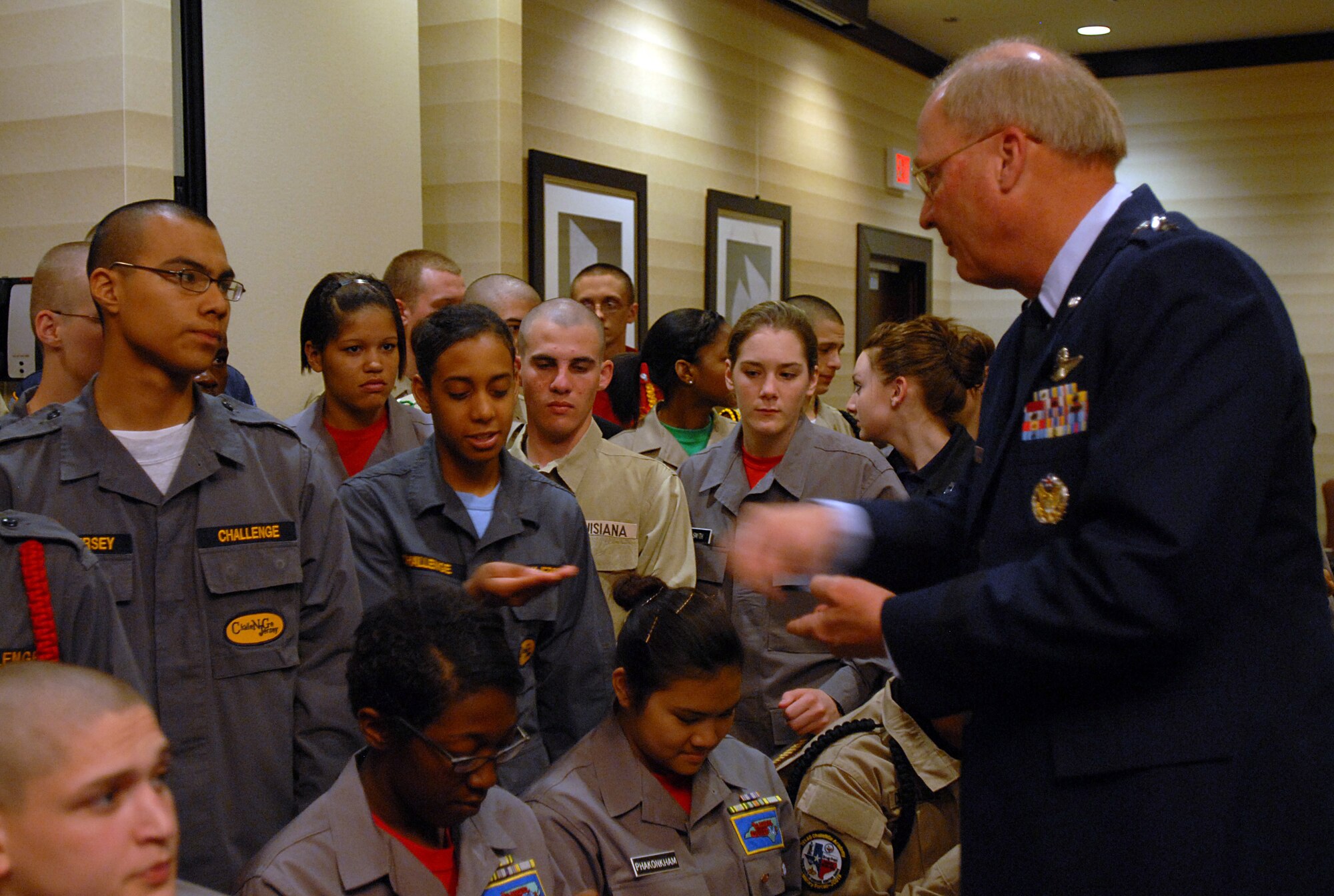 Air Force Gen. Craig McKinley, chief of the National Guard Bureau, gives every cadet his challenge coin as a keepsake before the National Guard Youth Foundation's 2011 ChalleNGe Champions Gala in Washington, March 1, 2011. Unique for this year's gala was the celebration of the program's 100,000th graduate, cadet Tori Walston, from Louisiana. (U.S. Army photo by Sgt. Darron Salzer) (Released)