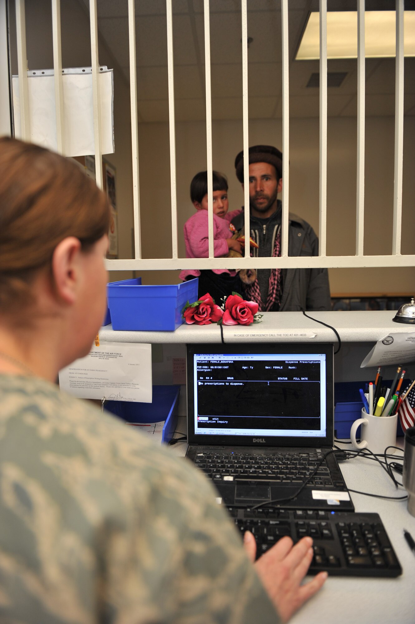Capt. Jennifer baker, 455th Expeditionary Medical Support Squadron, inputs an Afghan's information prior to picking up prescription medication at Craig Joint Theater Hospital, Bagram Airfield, Afghanistan, March 3, 2011. The CJTH Pharmacy dispenses an average of 6500 medication each month. (U.S. Air Force photo by Senior Airman Sheila deVera)