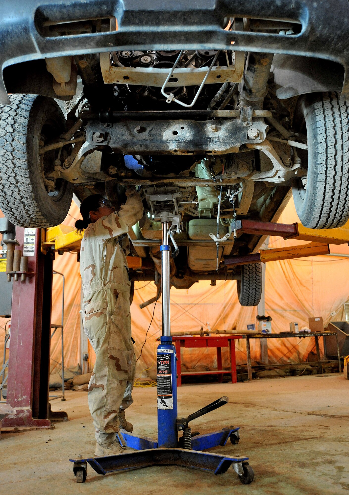 Senior Airman Catherine Carpenter, 407th Expeditionary Operations Support Squadron special purpose vehicle mechanic, works on a truck March 1, 2011, at Ali Air Base, Iraq. (U.S. Air Force photo by Senior Airman Andrew Lee/Released) 