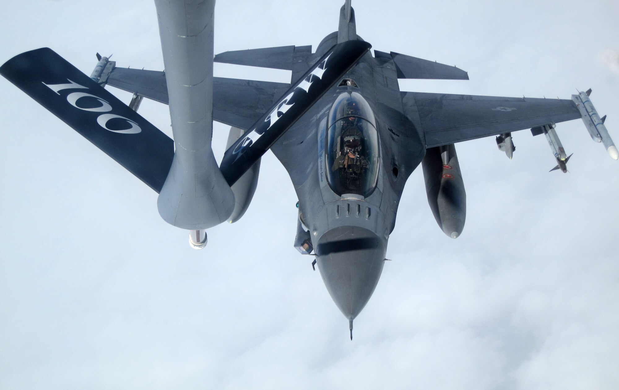 An F-16 Fighting Falcon pilot from Spangdahlem Air Base, Germany, aligns with a 100th Air Refueling Wing KC-135 Stratotanker boom to receive fuel as both aircraft fly over Germany, March 10, 2011. (U.S. Air Force photo/A1C Rachel Waller)