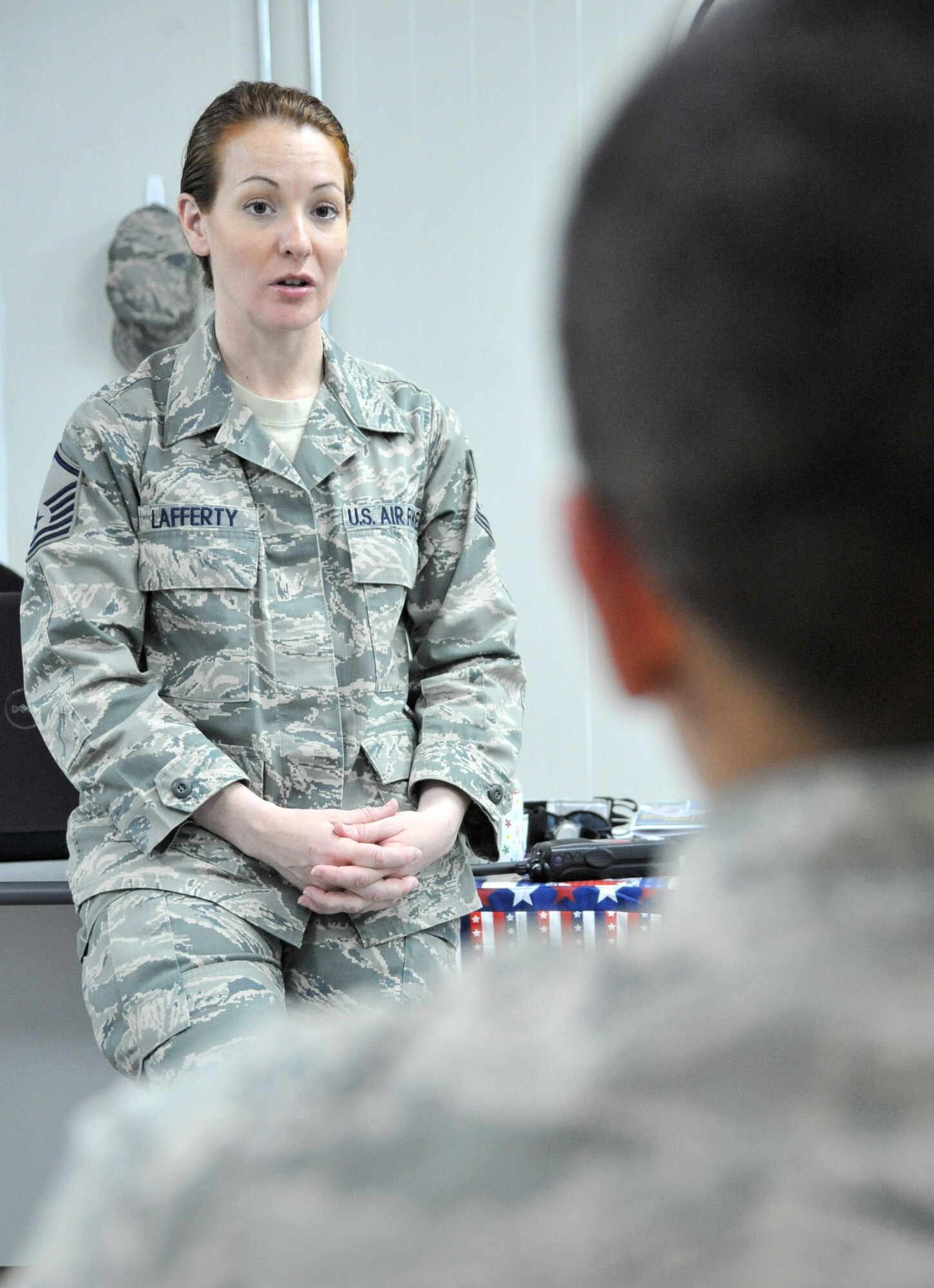 Master Sgt. Tammy Lafferty, 407th Air Expeditionary Group Learning Resource superintendent, talks to an Airman after he completed a test March 4, 2011, at Ali Air Base, Iraq. (U.S. Air Force photo by Senior Airman Andrew Lee/Released)