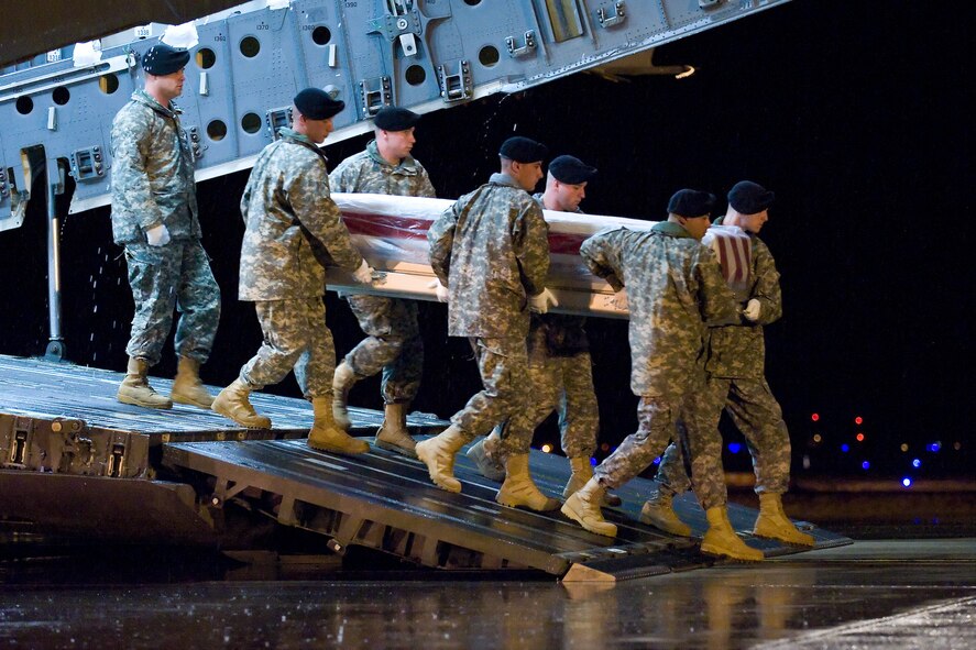 A U.S. Army carry team transfers the remains of Army Pfc. Kalin C. Johnson, of Lexington, S.C., at Dover Air Force Base, Del., March 10, 2011. Johnson was assigned to the 3rd Squadron, 2nd Stryker Cavalry Regiment, Vilseck, Germany. (U.S. Air Force photo/Roland Balik)