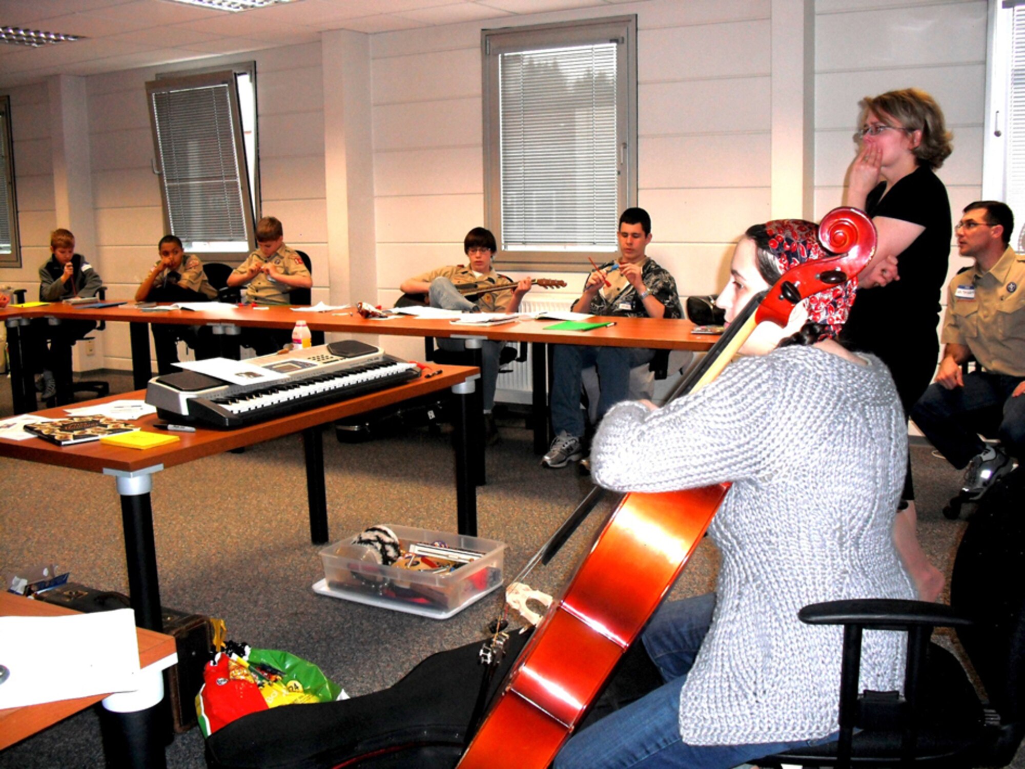 Instructor Rachel St. Martin (back right) and Liz Nye, cellist and director of last month's KMC Onstage production "Picasso at the Lapin Agile," teach the Boy Scouts all about music at a recent Merit Badge University hosted by the Boy Scouts of America Troop 69 and the Barbarossa District.